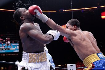 LAS VEGAS, NV - JUNE 20:  Adrien Broner (L) takes a punch from Shawn Porter during their welterweight fight at MGM Grand Garden Arena on June 20, 2015 in Las Vegas, Nevada. Porter won the fight by unanimous decision. (Photo by Steve Marcus/Getty Images)