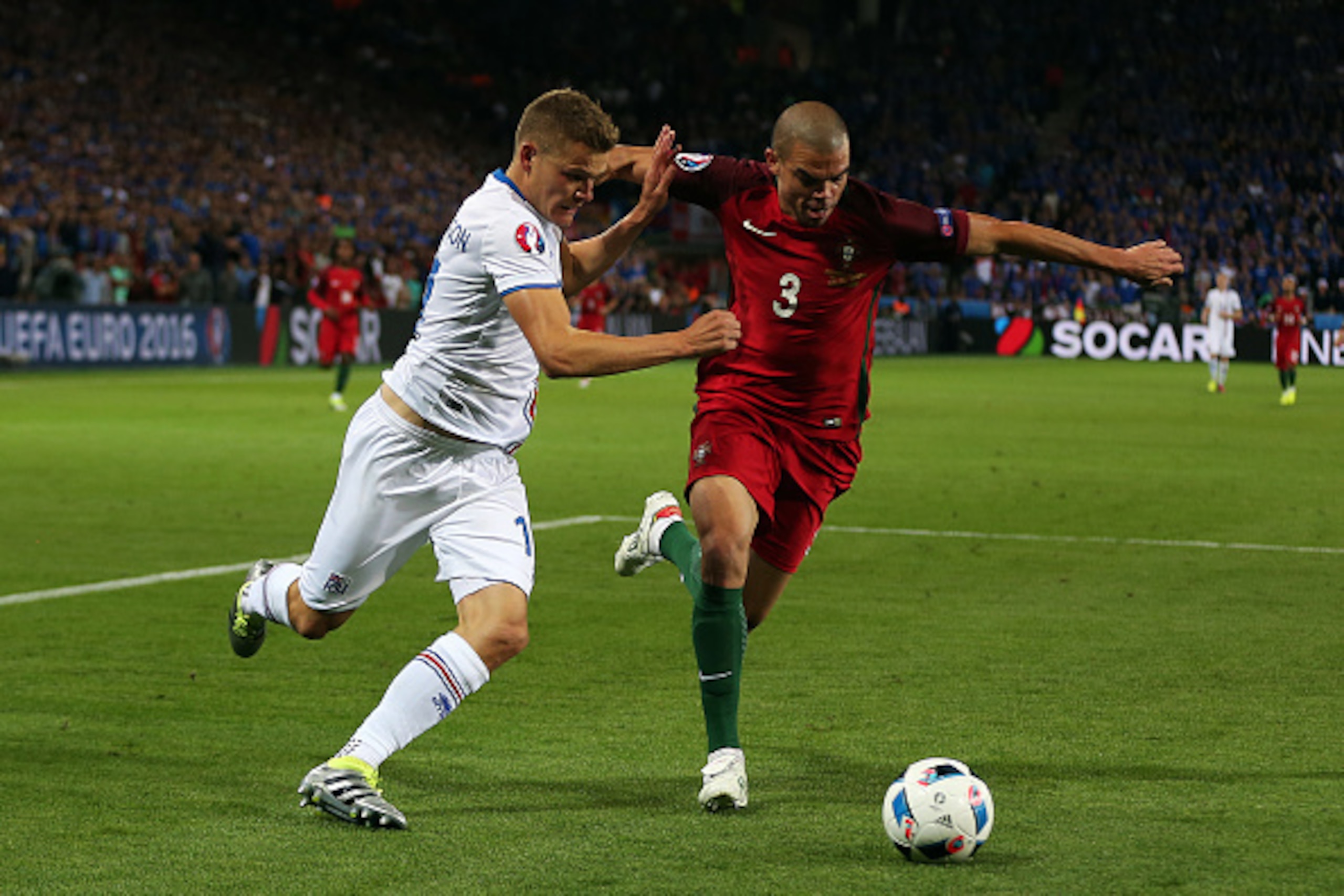 SAINT-ETIENNE, FRANCE - JUNE 14: Pepe of Portugal in action with Alfred Finnbogason of Iceland during the UEFA Euro 2016 Group F match between Portugal and Iceland at Stade Geoffroy-Guichard on June 14, 2016 in Saint-Etienne, France. (Photo by Chris Bruns