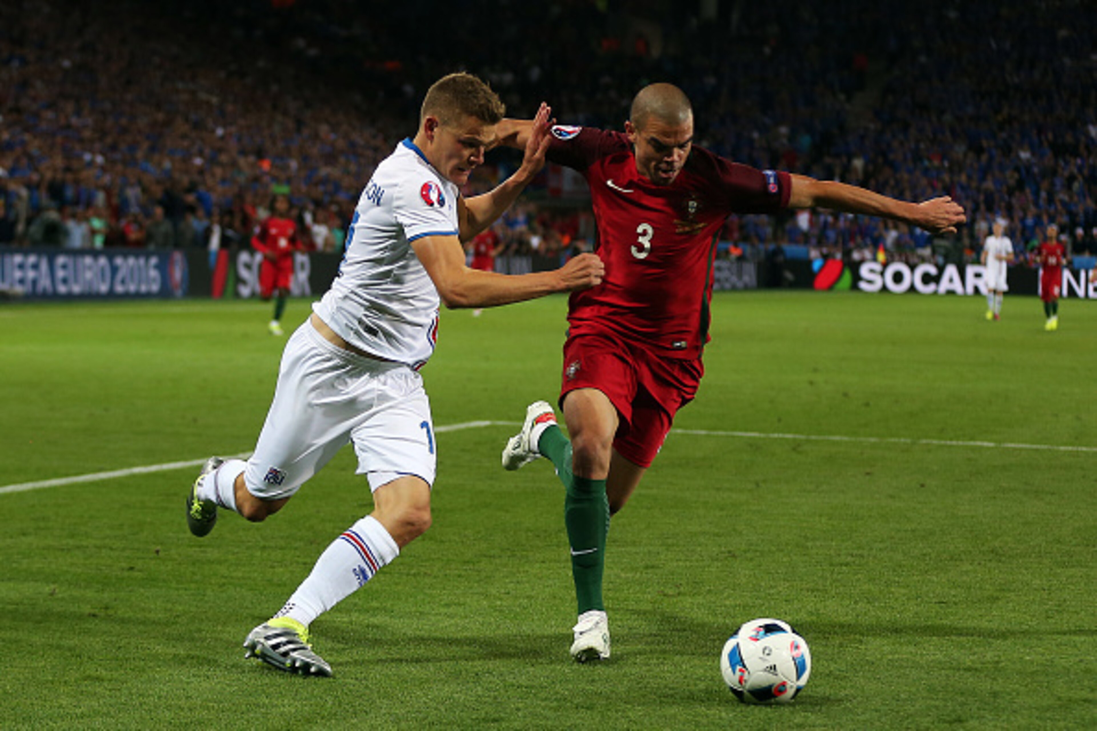 SAINT-ETIENNE, FRANCE - JUNE 14: Pepe of Portugal in action with Alfred Finnbogason of Iceland during the UEFA Euro 2016 Group F match between Portugal and Iceland at Stade Geoffroy-Guichard on June 14, 2016 in Saint-Etienne, France. (Photo by Chris Bruns