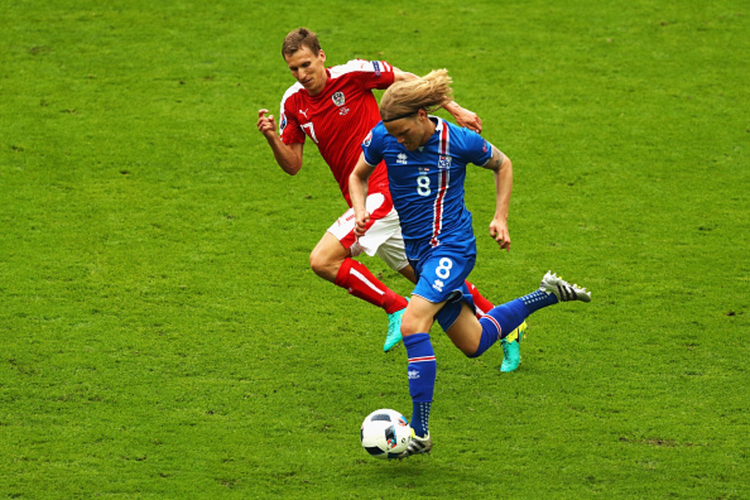 PARIS, FRANCE - JUNE 22:  Birkir Bjarnason of Iceland takes on Florian Klein of Austria during the UEFA EURO 2016 Group F match between Iceland and Austria at Stade de France on June 22, 2016 in Paris, France.  (Photo by Clive Mason/Getty Images)