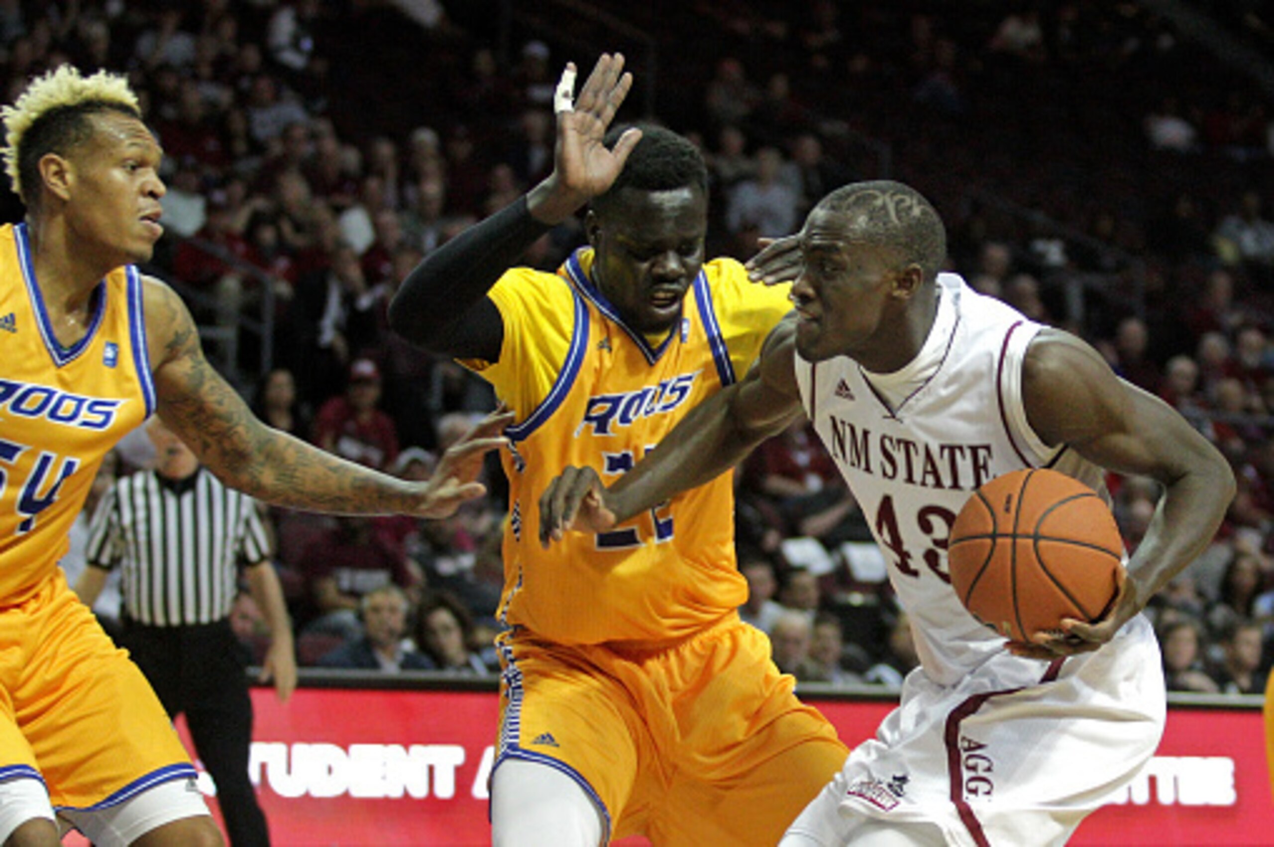 LAS VEGAS, NV - MARCH 11:  Darnell Tillman #54 and Shayok M. Shayok #22 of the Missouri-Kansas City Kangaroos guard Pascal Siakam #43 of the New Mexico State Aggies during a semifinal game of the Western Athletic Conference Basketball tournament at the Or