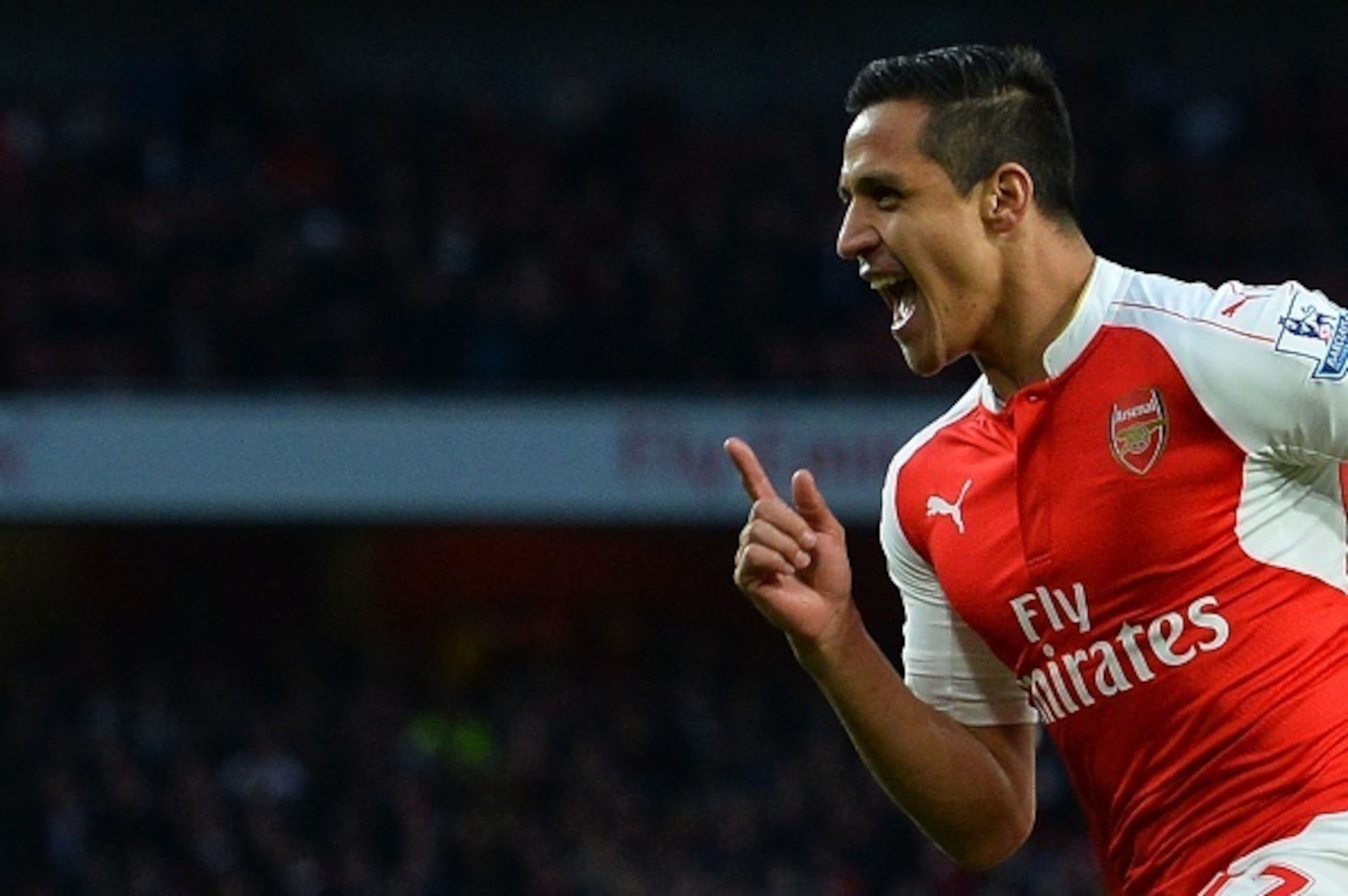 Arsenal's Chilean striker Alexis Sanchez celebrates scoring the opening goal during the English Premier League football match between Arsenal and West Bromwich Albion at the Emirates Stadium in London on April 21, 2016.  / AFP / GLYN KIRK / RESTRICTED TO 