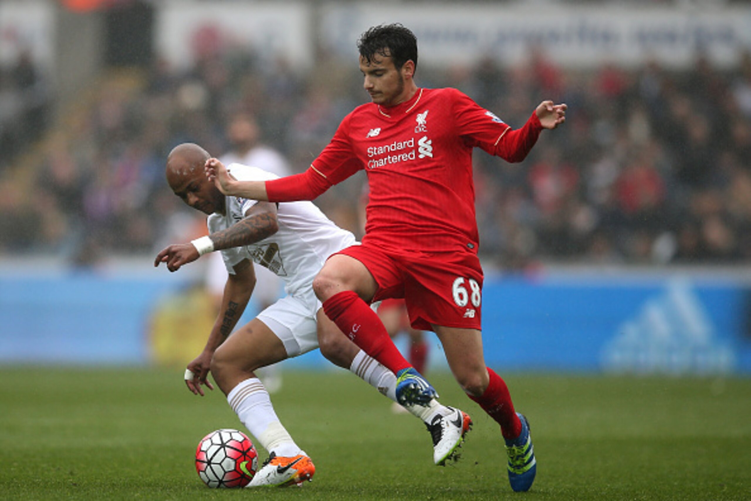 SWANSEA, WALES - MAY 01: Pedro Chirivella of Liverpool is closed down by Andre Ayew of Swansea City during the Barclays Premier League match between Swansea City and Liverpool at The Liberty Stadium on May 1, 2016 in Swansea, Wales.  (Photo by Steve Barde