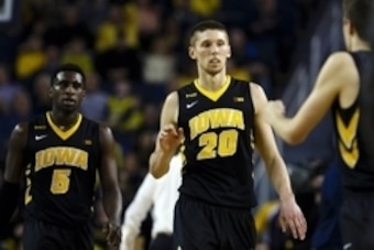 Mar 5, 2016; Ann Arbor, MI, USA; Iowa Hawkeyes guard Anthony Clemmons (5) and forward Jarrod Uthoff (20) walk back the the bench during a time out in the second half against the Michigan Wolverines at Crisler Center. Mandatory Credit: Rick Osentoski-USA T