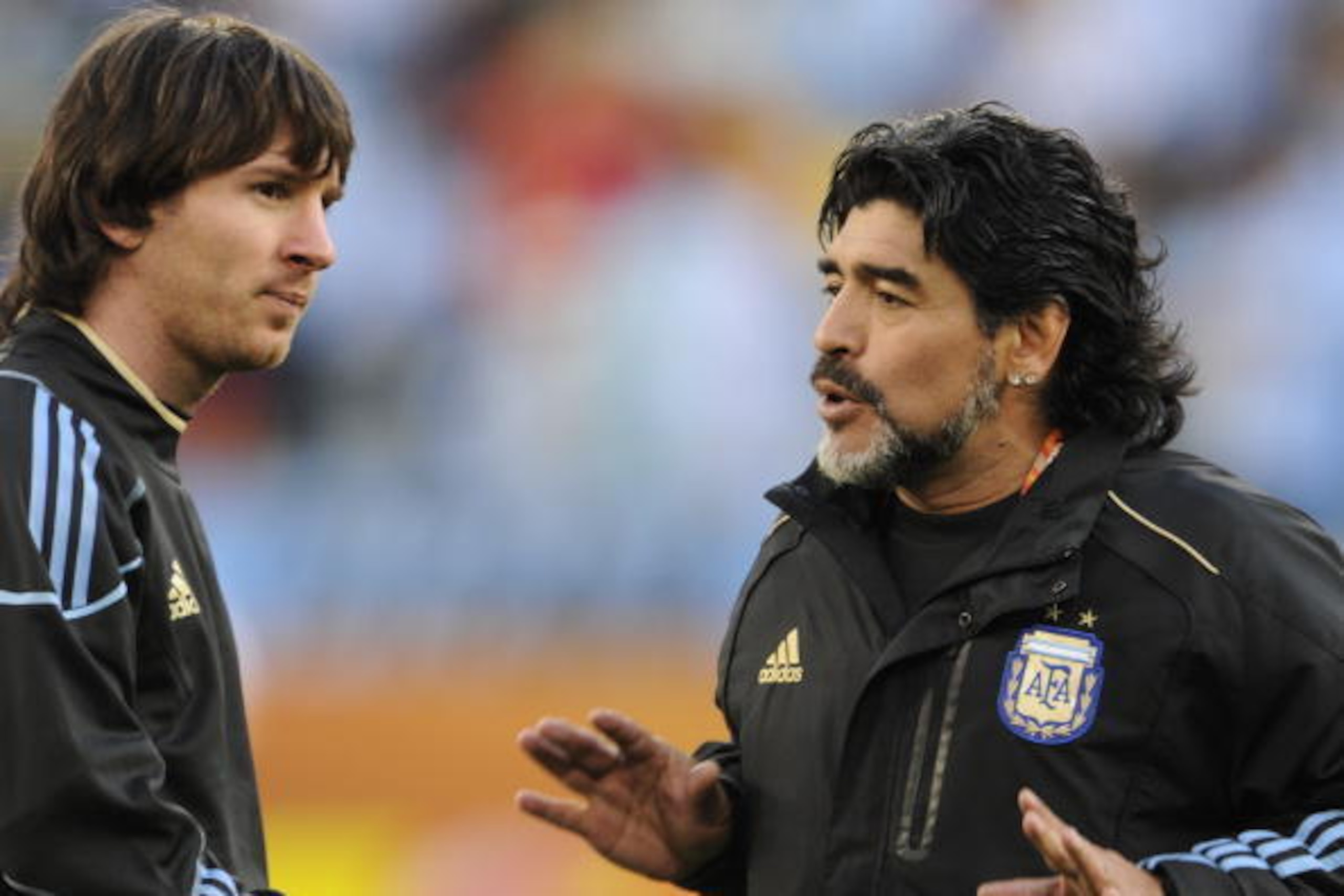 Argentina's coach Diego Maradona speaks to striker Lionel Messi before the start of the 2010 World Cup quarter-final football match Argentina vs. Germany on July 3, 2010 at Green Point stadium in Cape Town.  NO PUSH TO MOBILE / MOBILE USE SOLELY WITHIN ED