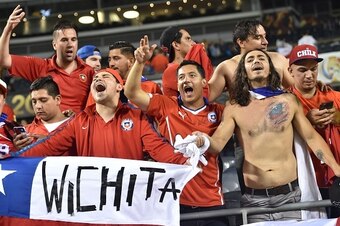 Fans of Chile cheer for their team at the end of the Copa America Centenario semifinal football match against Colombia, in Chicago, Illinois, United States, on June 22, 2016.  / AFP / Nicholas Kamm        (Photo credit should read NICHOLAS KAMM/AFP/Getty 
