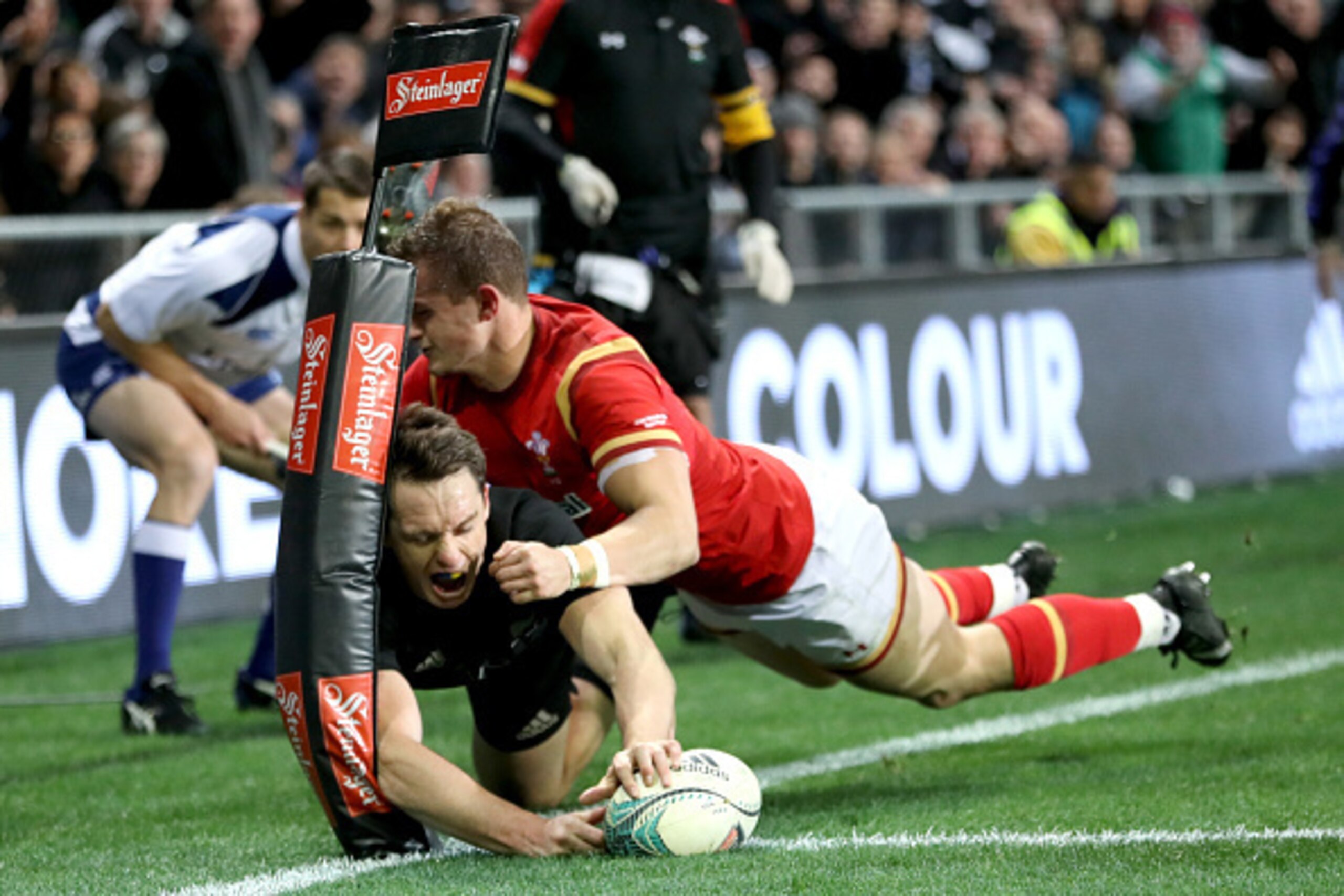 DUNEDIN, NEW ZEALAND - JUNE 25:  Ben Smith of the All Blacks scores a try in the tackle of Hallam Amos of Wales  during the International Test match between the New Zealand All Blacks and Wales at Forsyth Barr Stadium on June 25, 2016 in Dunedin, New Zeal