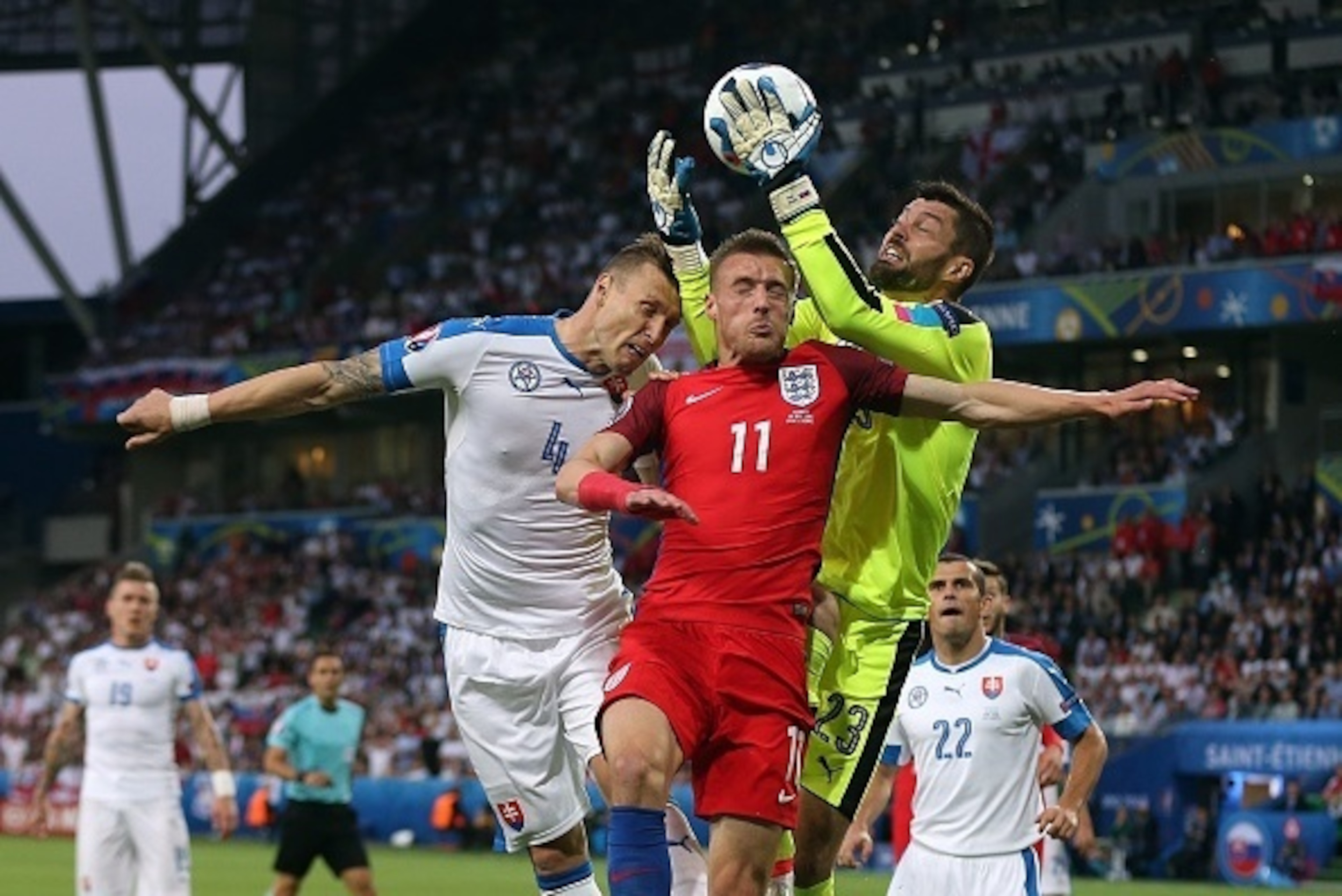 SAINT-ETIENNE, FRANCE - JUNE 20: Matus Kozacik of Slovakia and team-mate Jan Durica jump for a header with Jamie Vardy of England during the UEFA Euro 2016 Group B match between Slovakia and England at Stade Geoffroy-Guichard on June 20, 2016 in Saint-Eti