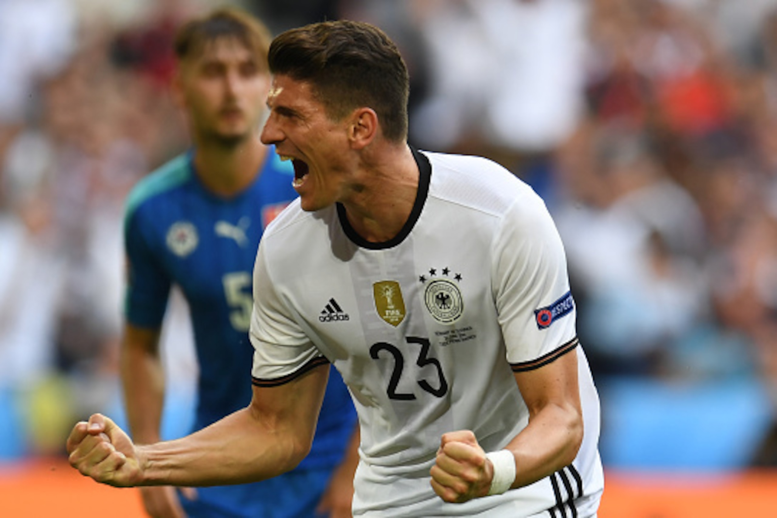 Germany's forward Mario Gomez celebrates after scoring a goal during the Euro 2016 round of 16 football match between Germany and Slovakia at the Pierre-Mauroy stadium in Villeneuve-d'Ascq near Lille on June 26, 2016. / AFP / PATRIK STOLLARZ        (Photo
