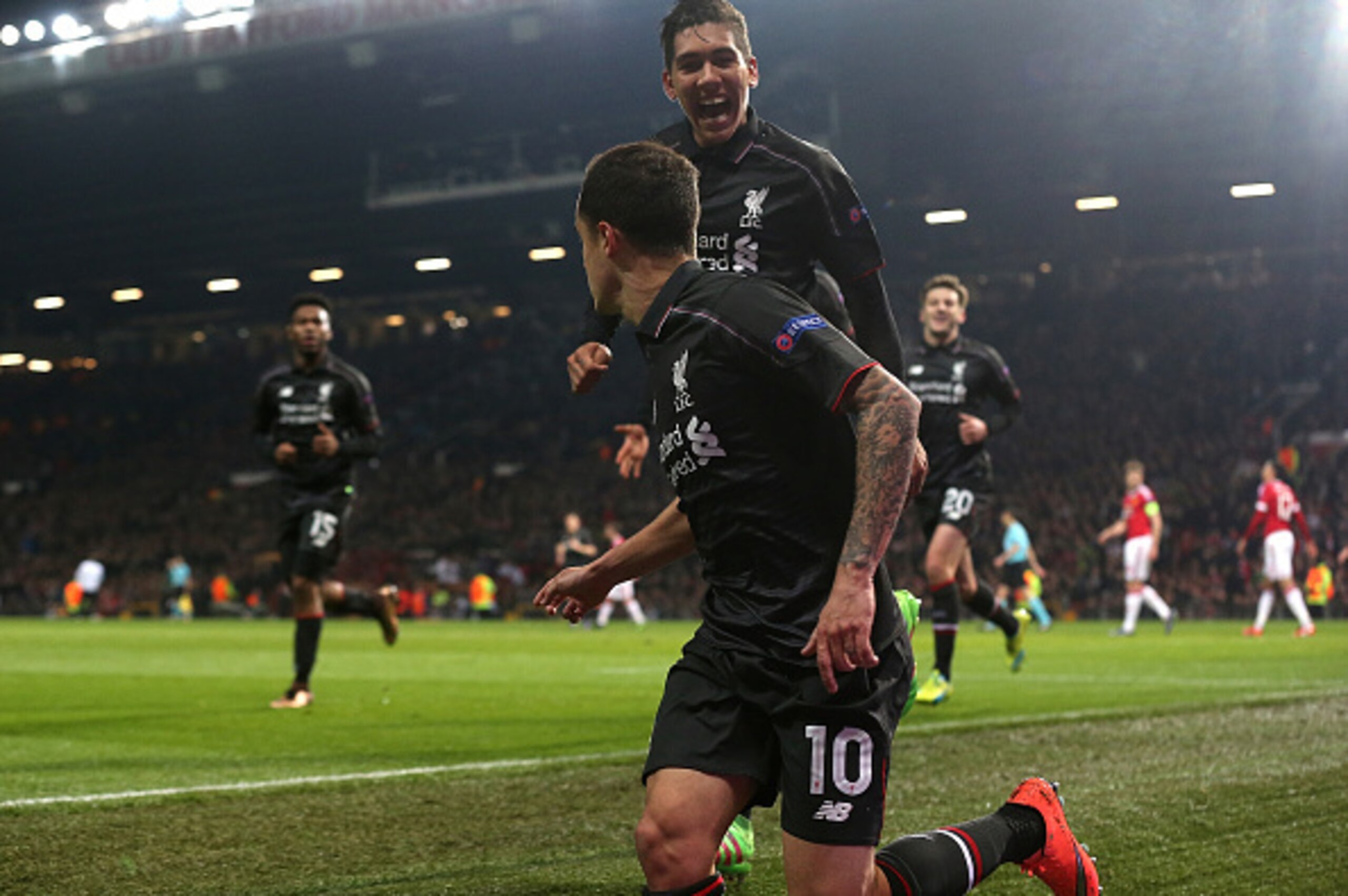 MANCHESTER, ENGLAND - MARCH 17:  Philippe Coutinho of Liverpool celebrates scoring his team's first goal with team-mate Roberto Firmino (R) during the UEFA Europa League Round of 16 Second Leg match between Manchester United and Liverpool at Old Trafford 