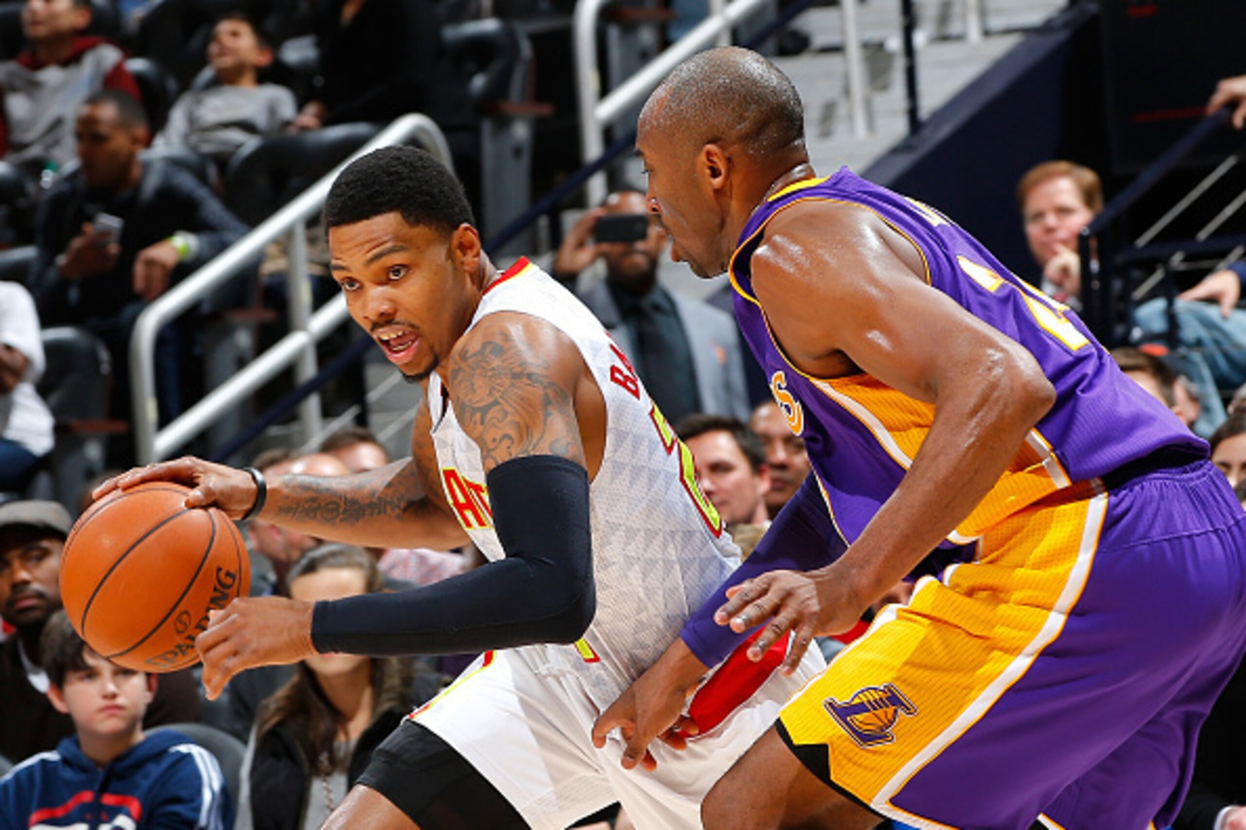 ATLANTA, GA - DECEMBER 04:  Kent Bazemore #24 of the Atlanta Hawks drives against Kobe Bryant #24 of the Los Angeles Lakers at Philips Arena on December 4, 2015 in Atlanta, Georgia.  NOTE TO USER User expressly acknowledges and agrees that, by downloading