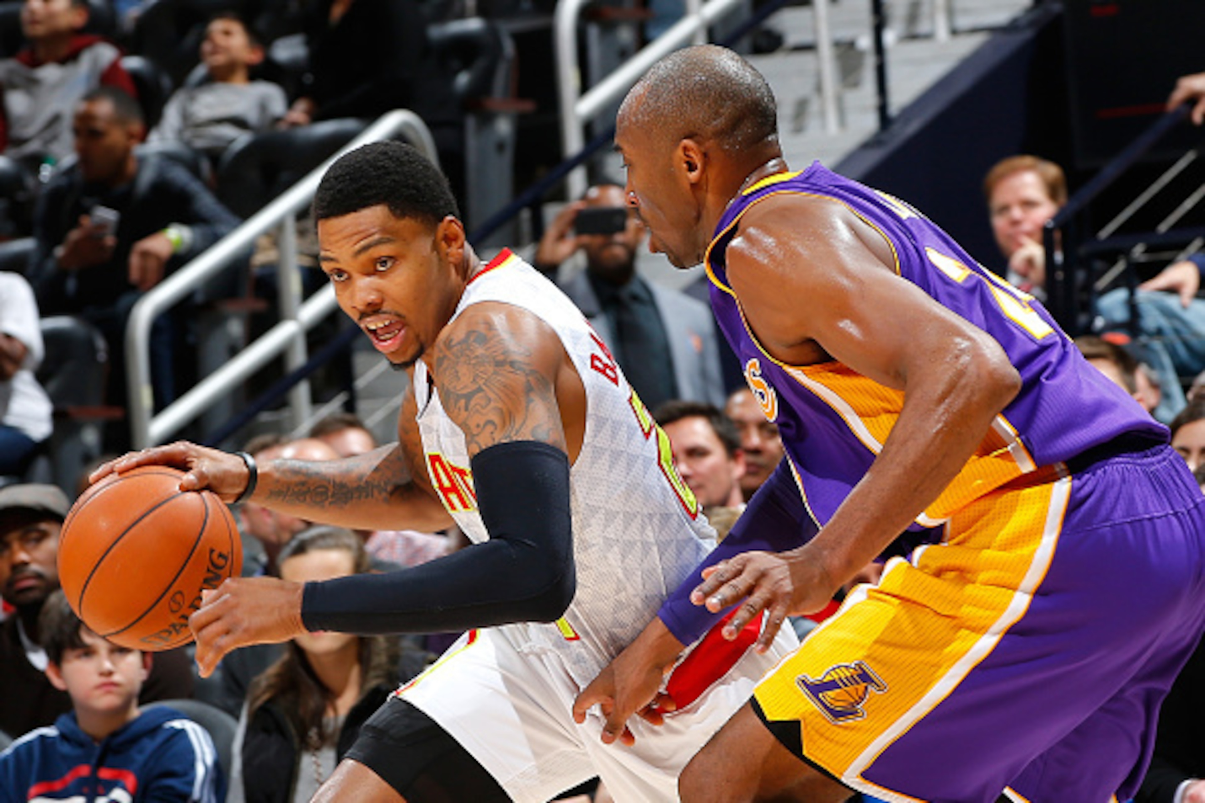 ATLANTA, GA - DECEMBER 04:  Kent Bazemore #24 of the Atlanta Hawks drives against Kobe Bryant #24 of the Los Angeles Lakers at Philips Arena on December 4, 2015 in Atlanta, Georgia.  NOTE TO USER User expressly acknowledges and agrees that, by downloading