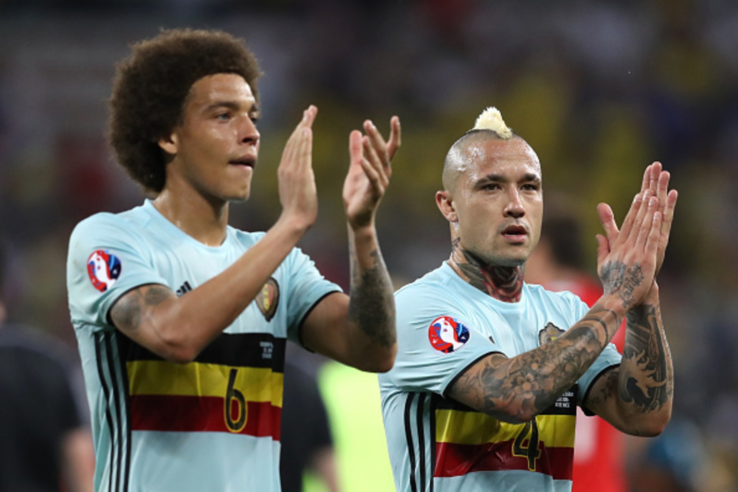 Belgium's midfielder Axel Witsel (L) and Belgium's midfielder Radja Nainggolan acknowledge the fans after beating Sweden 1-0 in the Euro 2016 group E football match between Sweden and Belgium at the Allianz Riviera stadium in Nice on June 22, 2016. / AFP 