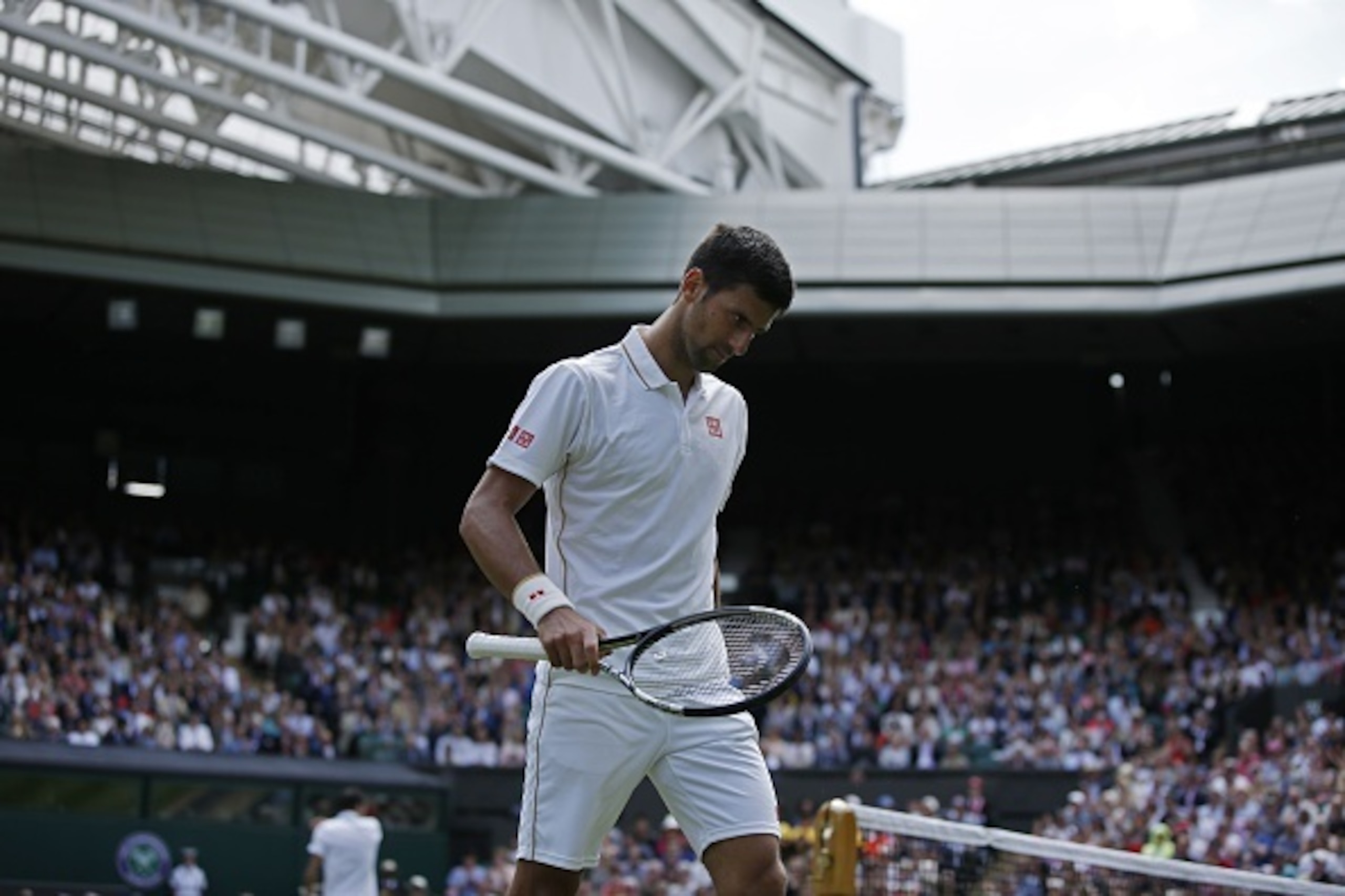 Serbia's Novak Djokovic returns to his baseline after losing a game in the second set against Britain's James Ward during their men's singles first round match on the first day of the 2016 Wimbledon Championships at The All England Lawn Tennis Club in Wim