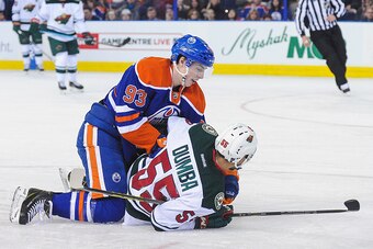 EDMONTON, AB - FEBRUARY 20: Ryan Nugent-Hopkins #93 of the Edmonton Oilers checks Matt Dumba #55 of the Minnesota Wild during an NHL game at Rexall Place on February 20, 2015 in Edmonton, Alberta, Canada. (Photo by Derek Leung/Getty Images)