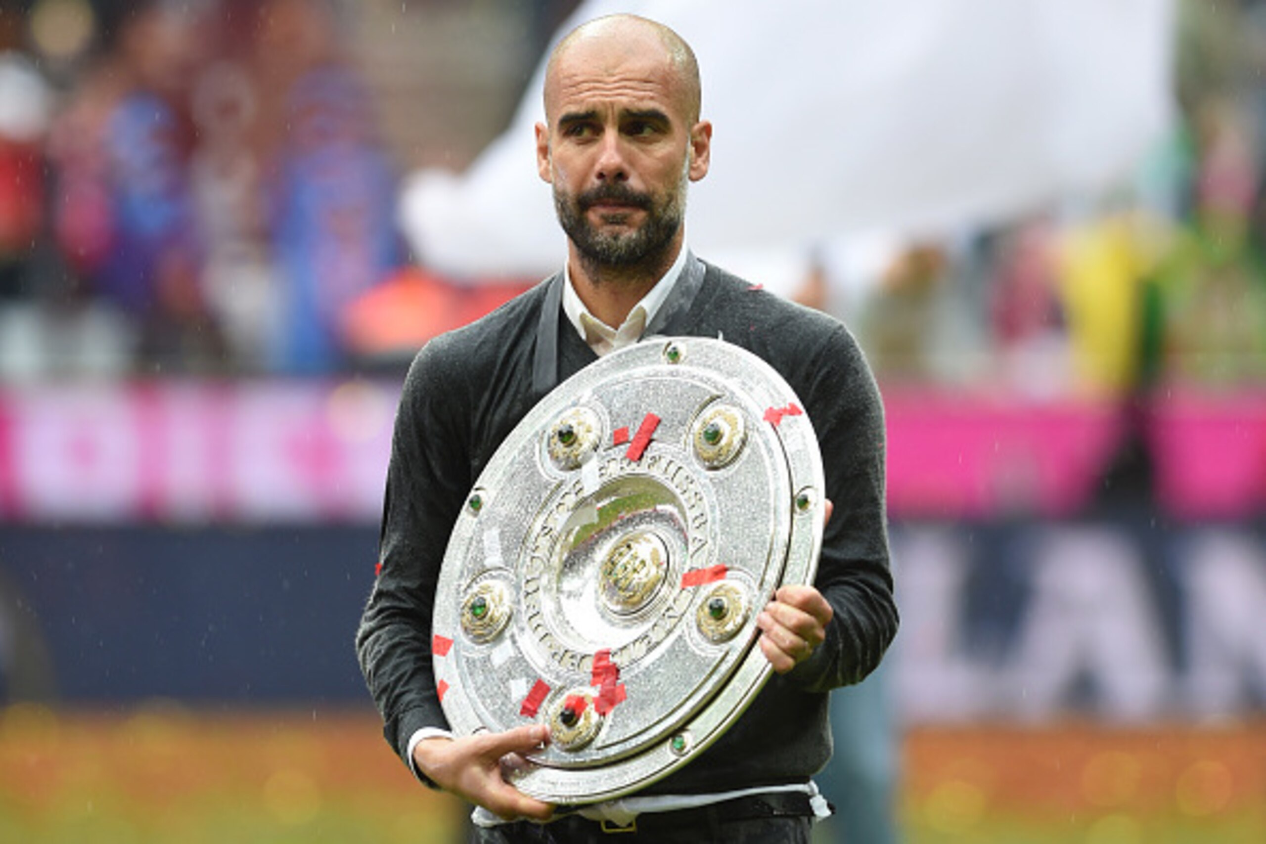 Bayern Munich's Spanish head coach Pep Guardiola celebrates with Bundesliga trophy after the German first division Bundesliga football match between FC Bayern Munich and Hannover 96 in Munich, southern Germany, on May 14, 2016. / AFP / Christof STACHE / R
