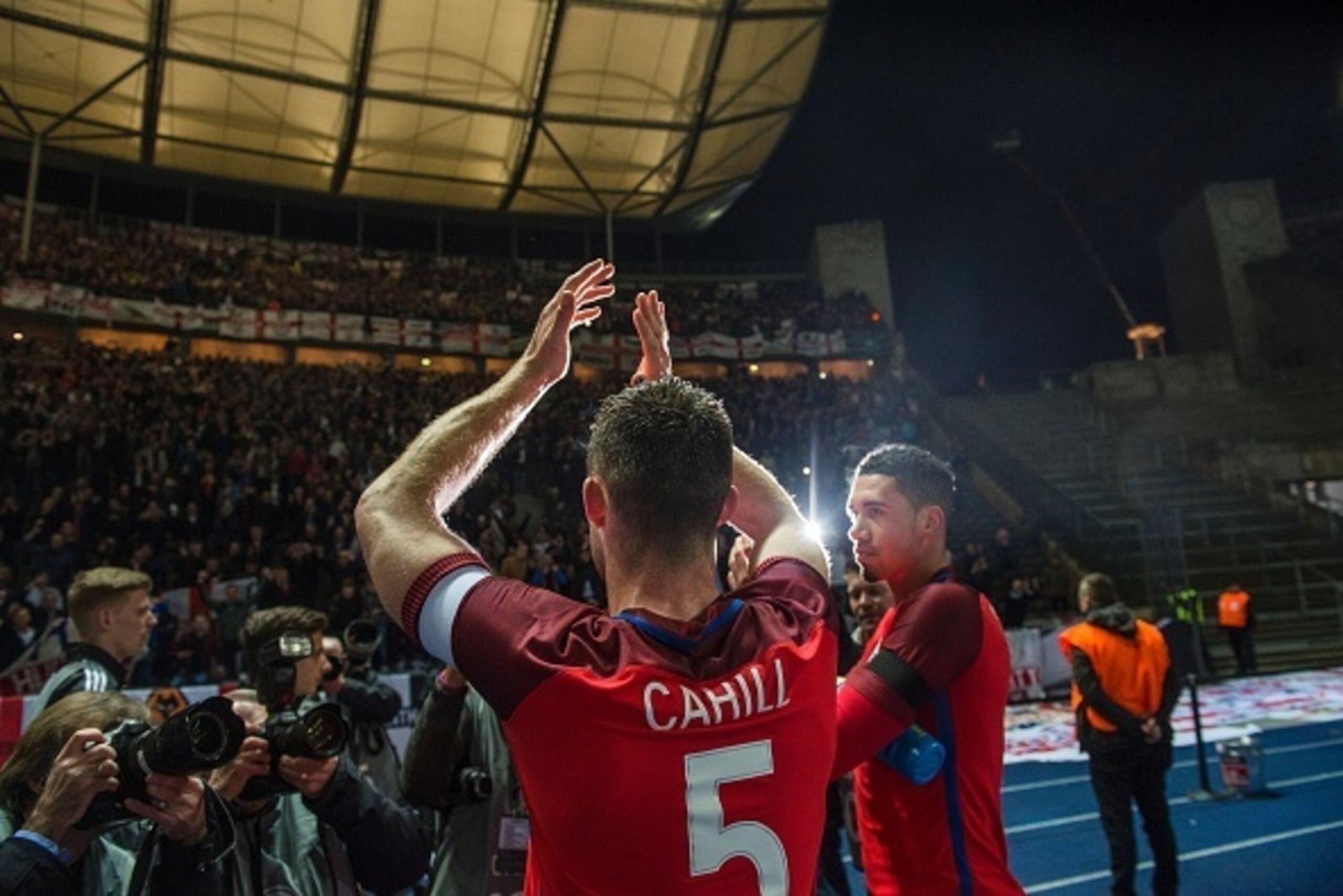 England's defender Gary Cahill greet traveling fans after the final whistle of the friendly football match Germany v England at the Olympic Stadium in Berlin on March 26, 2016.
England won the match 2-3. / AFP / ODD ANDERSEN        (Photo credit should re