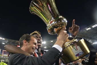 Juventus' coach Massimiliano Allegri (L) and Juventus' midfielder from France Paul Pogba celebrate with the trophy after winning 2-1 the Italian Tim Cup final match (Coppa Italia) between Juventus and Lazio on May 20, 2015 at the Stadio Olimpico in Rome. 