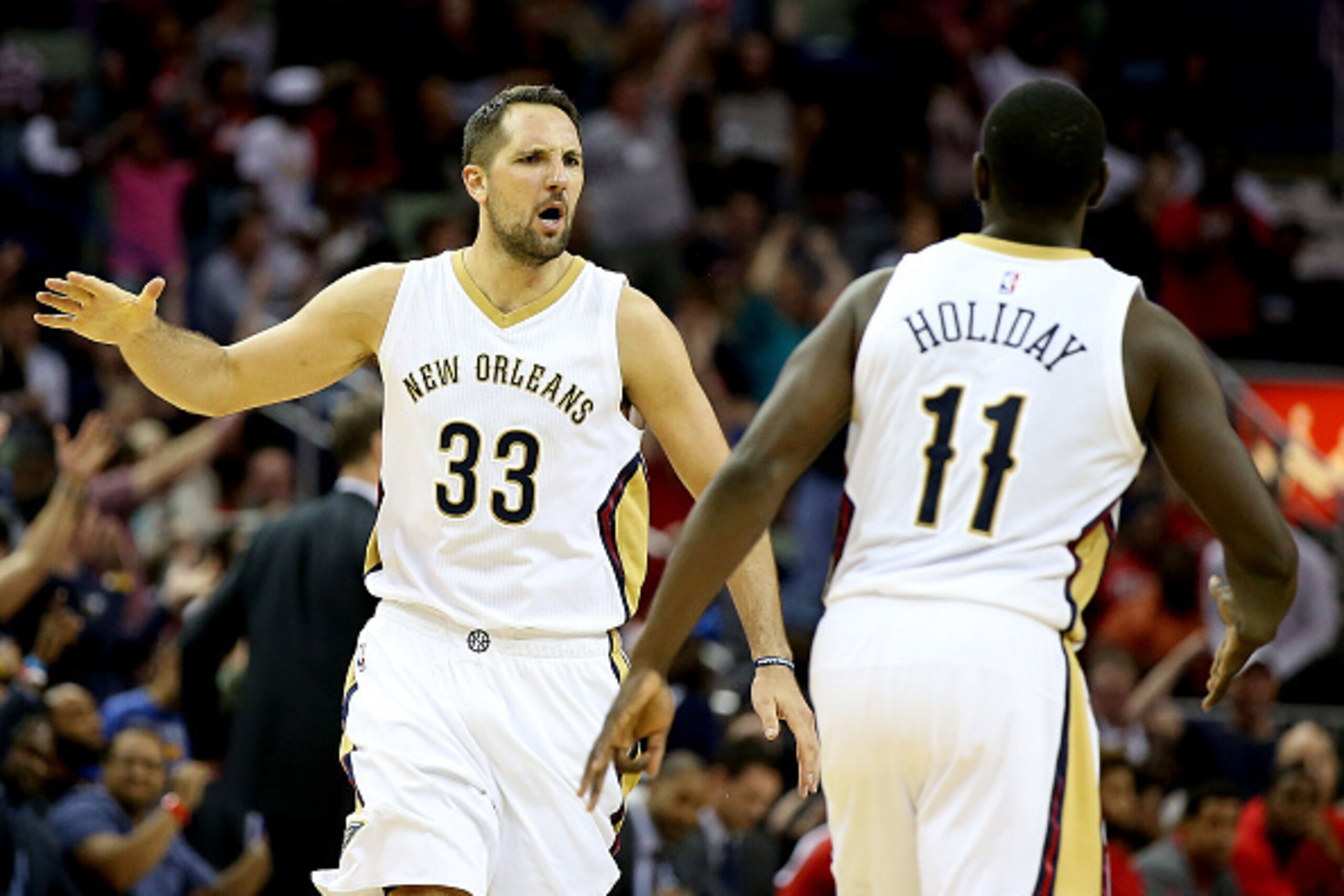 NEW ORLEANS, LA - MARCH 18:  Ryan Anderson #33 of the New Orleans Pelicans react to a play with Jrue Holiday #11 of the New Orleans Pelicans as tthey take on the Portland Trail Blazers during the first half at the Smoothie King Center on March 18, 2016 in