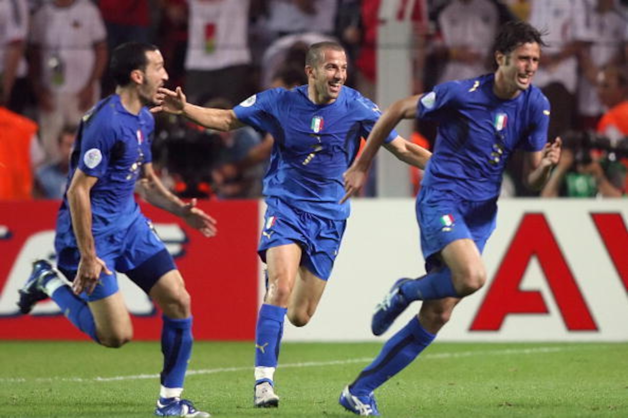 Dortmund, GERMANY:  Italian defender Fabio Grosso (R) celebrates his goal in extra time with Italian forward Alessandro Del Piero (C) and Italian defender Gianluca Zambrotta (L) during the semi-final World Cup football match between Germany and Italy at D