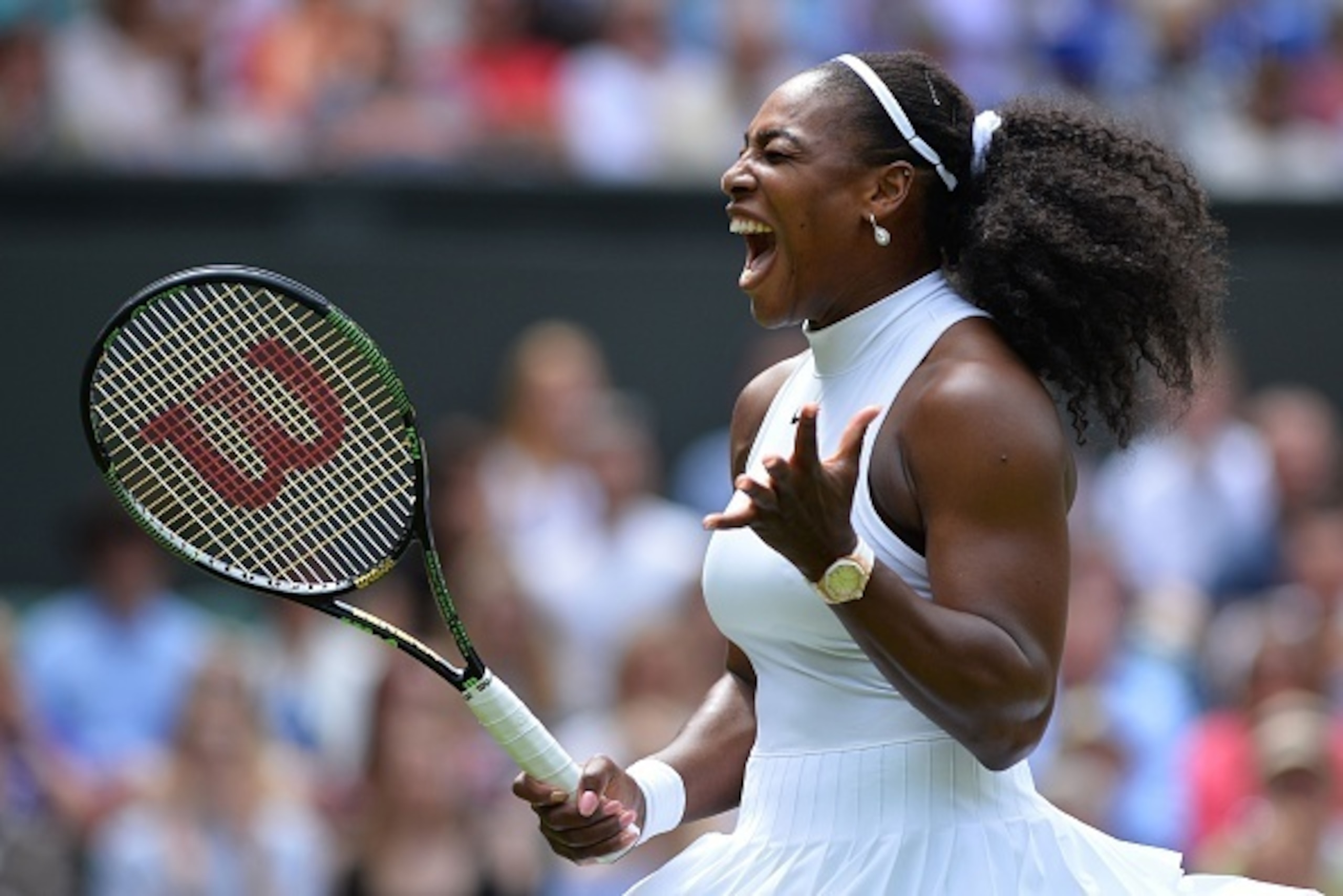 US player Serena Williams reacts after a point against Switzerland's Amra Sadikovic during their women's singles first round match on the second day of the 2016 Wimbledon Championships at The All England Lawn Tennis Club in Wimbledon, southwest London, on