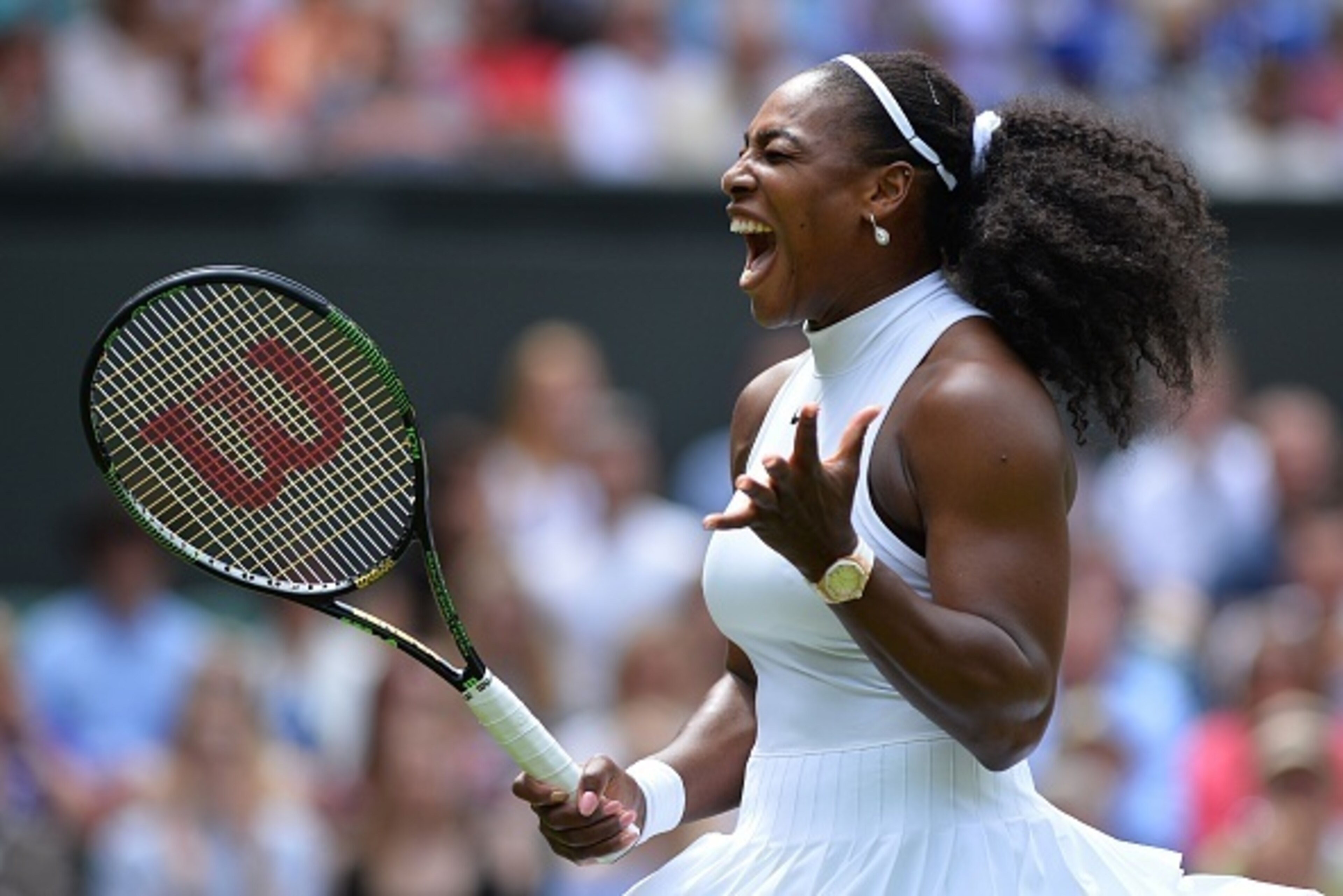 US player Serena Williams reacts after a point against Switzerland's Amra Sadikovic during their women's singles first round match on the second day of the 2016 Wimbledon Championships at The All England Lawn Tennis Club in Wimbledon, southwest London, on