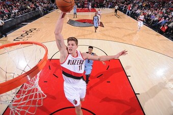 PORTLAND, OR - JANUARY 4:  Meyers Leonard #11 of the Portland Trail Blazers dunks the ball against the Memphis Grizzlies on January 4, 2015 at the Moda Center Arena in Portland, Oregon. NOTE TO USER: User expressly acknowledges and agrees that, by downloa