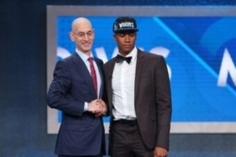 Jun 23, 2016; New York, NY, USA; Kris Dunn (Providence) greets NBA commissioner Adam Silver  after being selected as the number five overall pick to the Minnesota Timberwolves in the first round of the 2016 NBA Draft at Barclays Center. Mandatory Credit: 