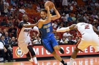 Apr 10, 2016; Miami, FL, USA; Orlando Magic guard Evan Fournier (center) drives to the basket past Miami Heat guard Dwyane Wade (left) and forward Joe Johnson (right) during the first half at American Airlines Arena. Mandatory Credit: Steve Mitchell-USA T Apr 10, 2016; Miami, FL, USA; Orlando Magic guard Evan Fournier (center) drives to the basket past Miami Heat guard Dwyane Wade (left) and forward Joe Johnson (right) during the first half at American Airlines Arena. Mandatory Credit: Steve Mitchell-USA T