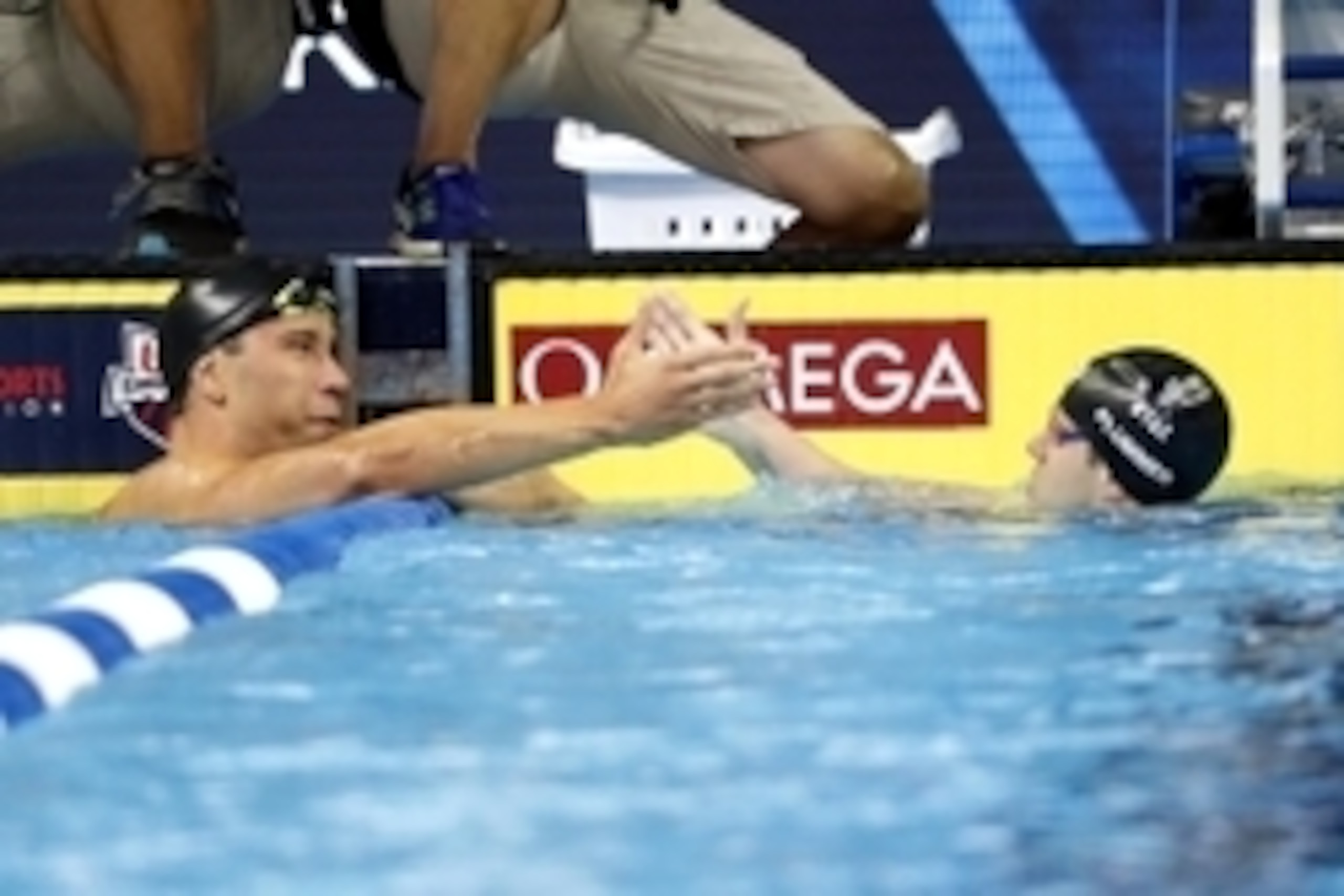 Jun 27, 2016; Omaha, NE, USA; Matt Grevers and David Plummer react after the men's backstroke 100m semi-final in the U.S. Olympic swimming team trials at CenturyLink Center. Mandatory Credit: Erich Schlegel-USA TODAY Sports