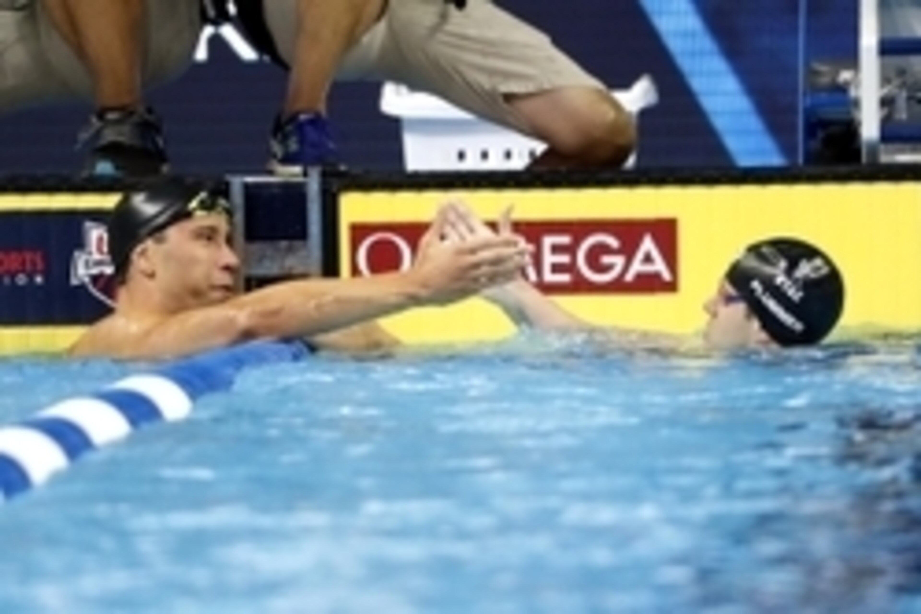 Jun 27, 2016; Omaha, NE, USA; Matt Grevers and David Plummer react after the men's backstroke 100m semi-final in the U.S. Olympic swimming team trials at CenturyLink Center. Mandatory Credit: Erich Schlegel-USA TODAY Sports