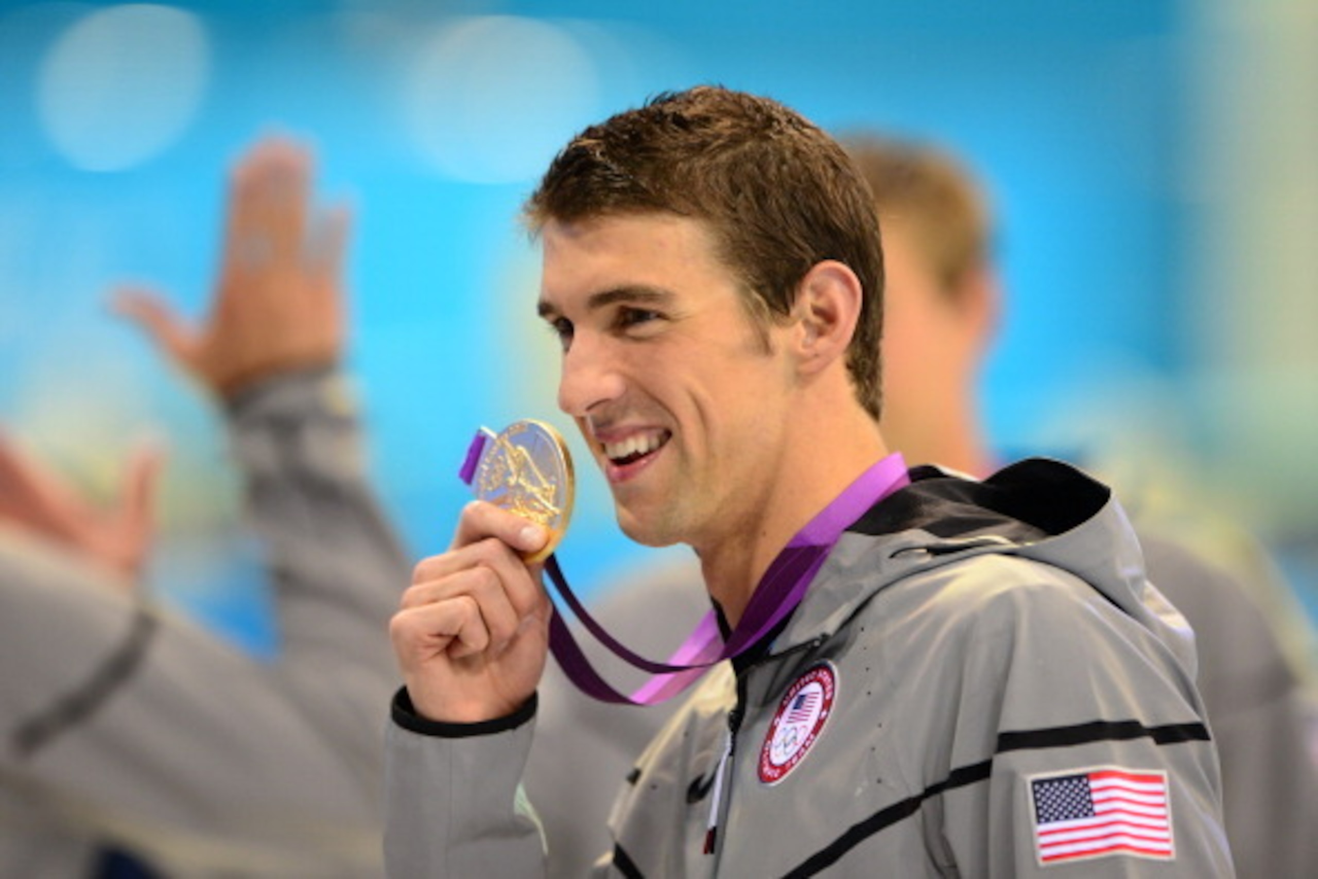 US swimmer Michael Phelps poses on the podium with the gold medal flanked by silver medalist and bronze medalist after winning the men's 4x100 medley relay final during the swimming event at the London 2012 Olympic Games on August 4, 2012 in London. Phelp