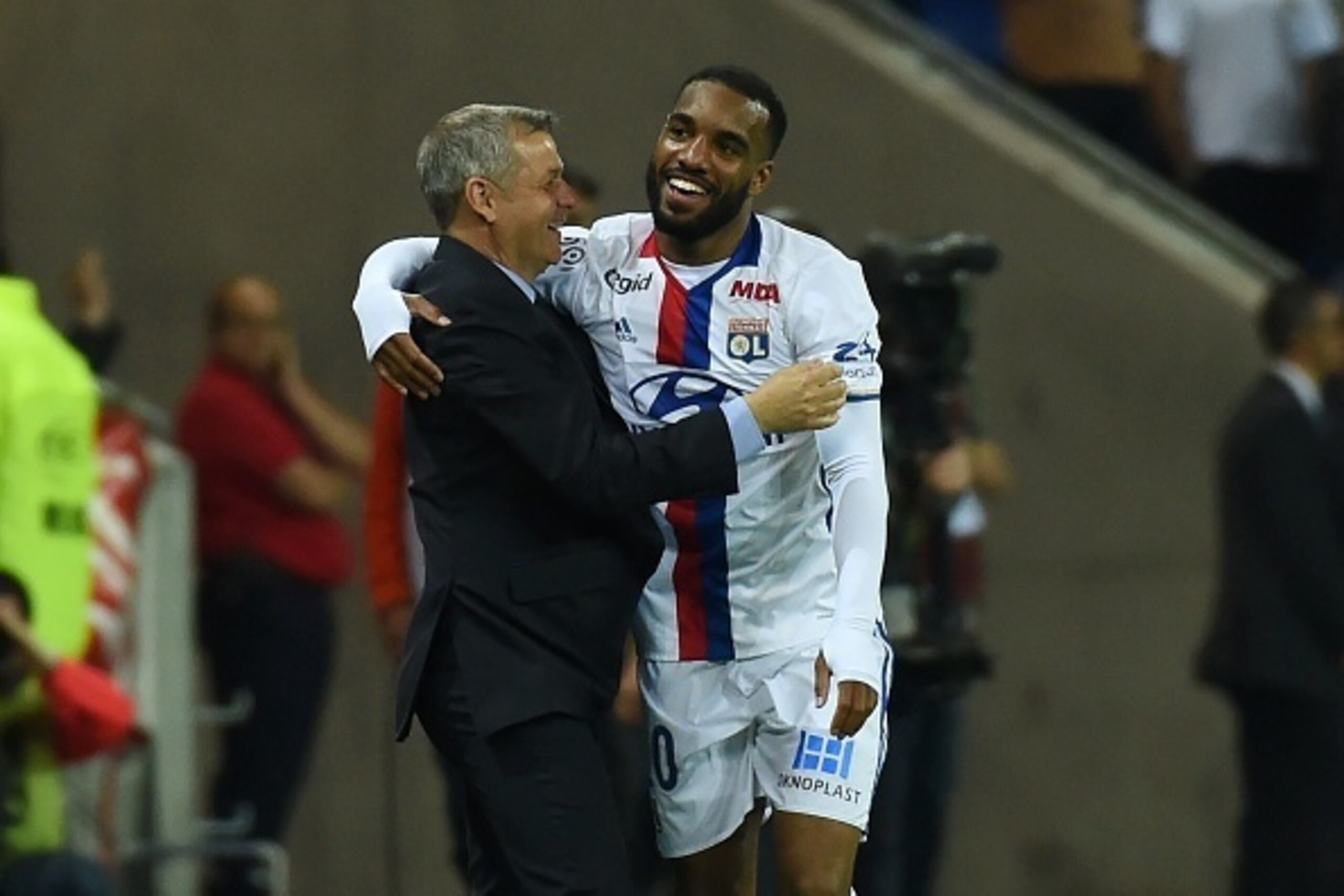 Lyon's French forward Alexandre Lacazette (R) is congratuled by Lyon's French head coach Bruno Genesio (L) after scoring during the French L1 football match Olympique Lyonnais and AS Monaco on May 7, 2016, at the New Stadium in Decines-Charpieu near Lyon,