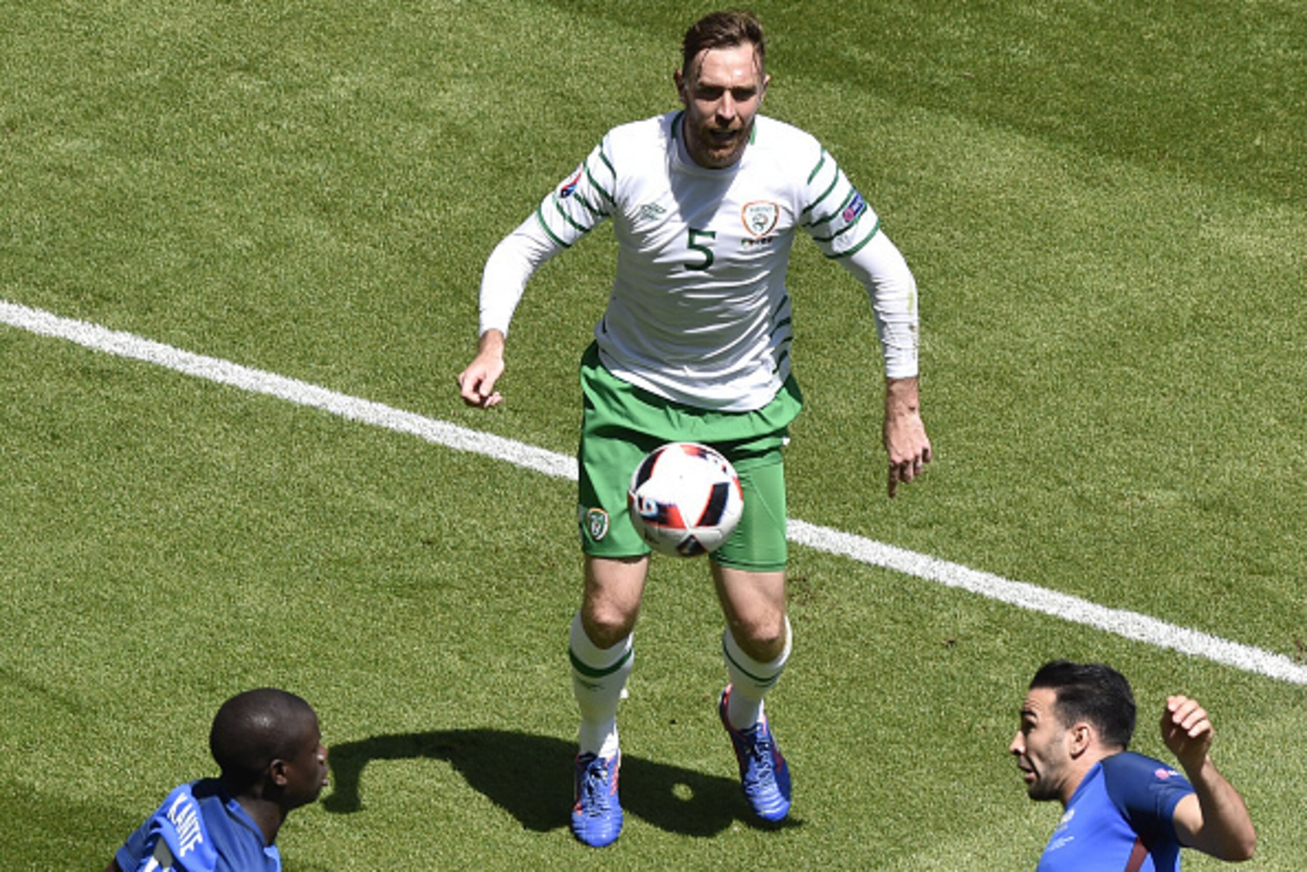 Ireland's defender Richard Keogh (C) and France's midfielder N'Golo Kante (L) and France's defender Adil Rami vie for the ball during the Euro 2016 round of 16 football match between France and Republic of Ireland at the Parc Olympique Lyonnais stadium in