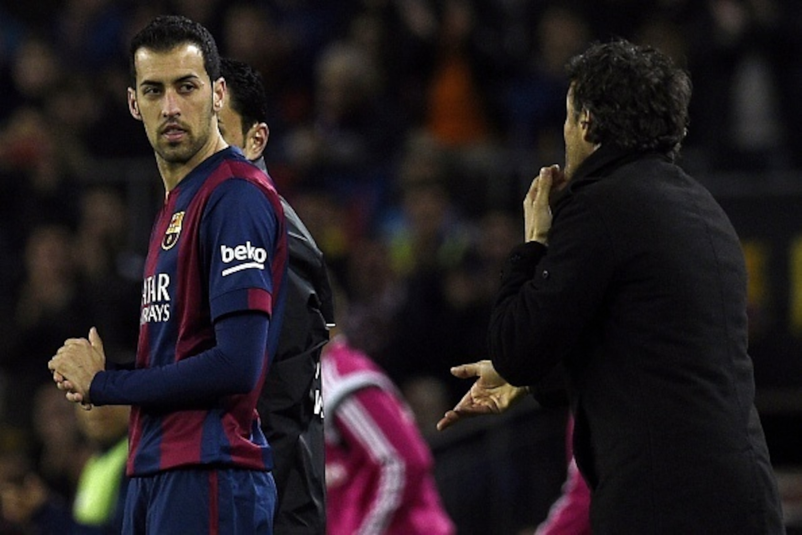 Barcelona's coach Luis Enrique (R) gives instructions to Barcelona's midfielder Sergio Busquets (L) during the 'clasico' Spanish league football match FC Barcelona vs Real Madrid CF at the Camp Nou stadium in Barcelona on March 22, 2015.    AFP PHOTO / LL