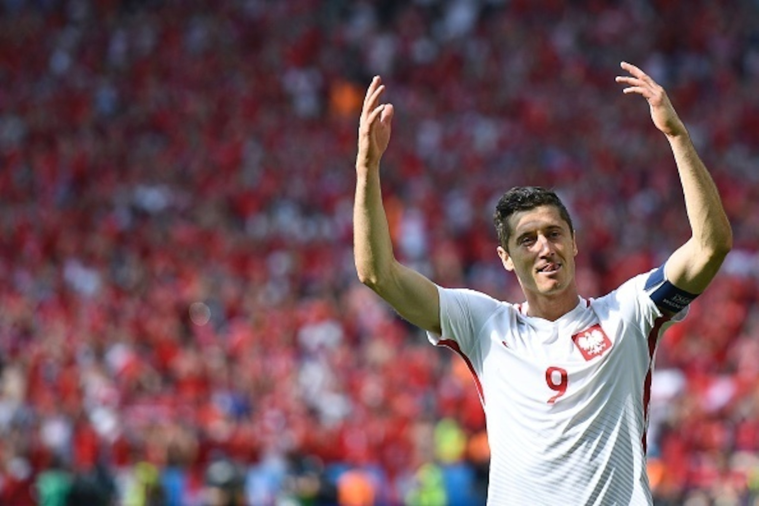 Poland's forward Robert Lewandowski celebrates his team's victory during the Euro 2016 round of sixteen football match Switzerland vs Poland, on June 25, 2016 at the Geoffroy Guichard stadium in Saint-Etienne. / AFP / MARTIN BUREAU        (Photo credit sh