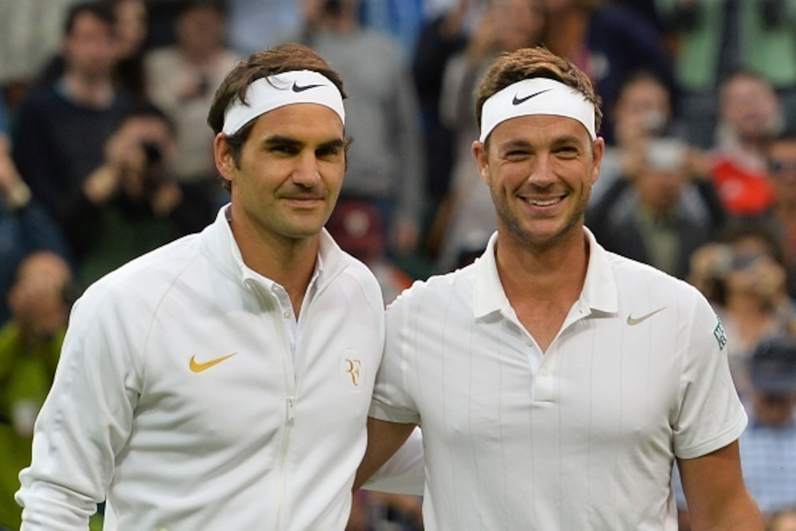 Britain's Marcus Willis (R) poses with opponent Switzerland's Roger Federer (L) at the start of their men's singles second round match on the third day of the 2016 Wimbledon Championships at The All England Lawn Tennis Club in Wimbledon, southwest London,