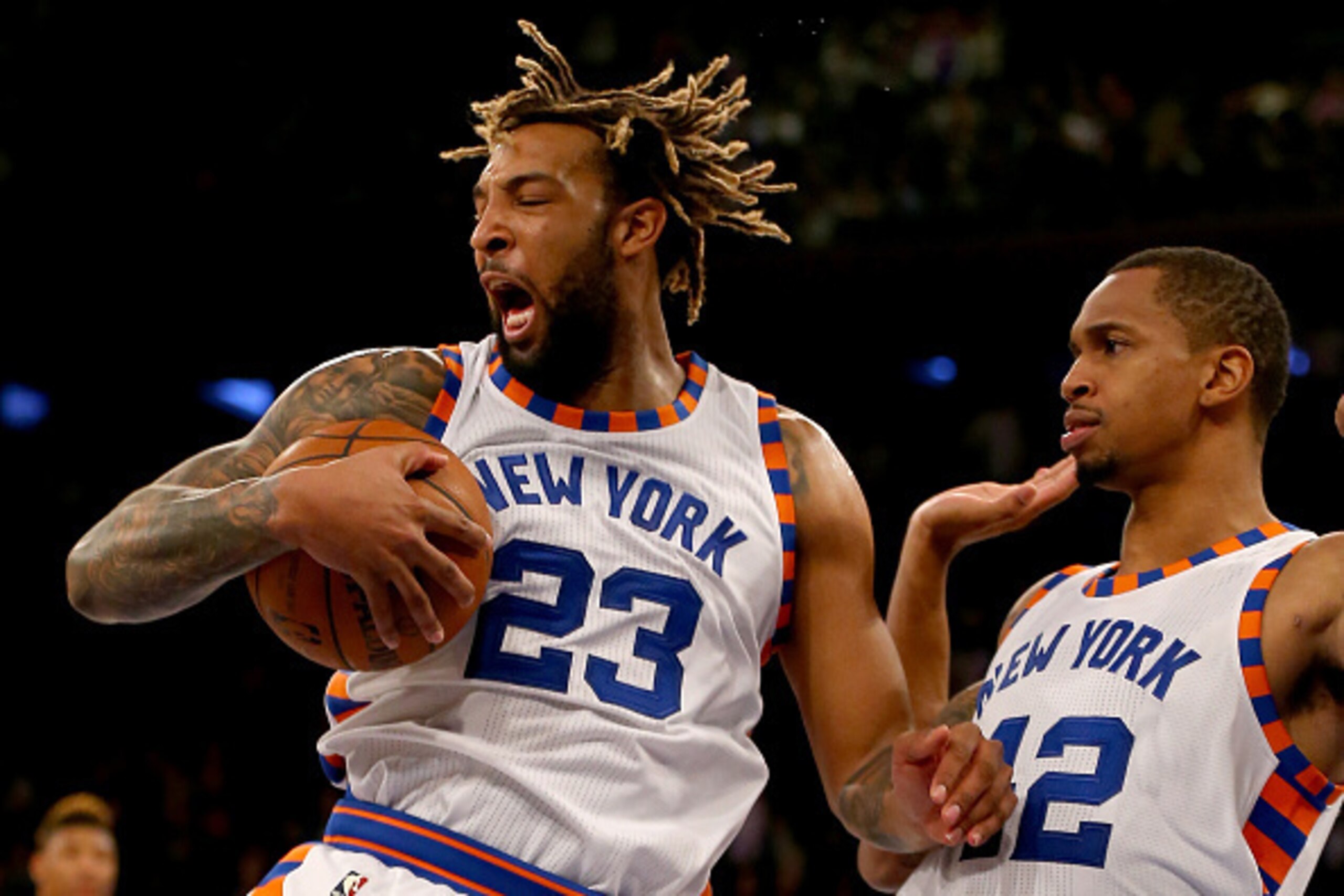 NEW YORK, NY - JANUARY 12: Derrick Williams #23 of the New York Knicks reacts after he grabs the rebound in the final minute of the game as teammate Lance Thomas #42 looks on against the Boston Celtics at Madison Square Garden on January 12, 2016 in New Y