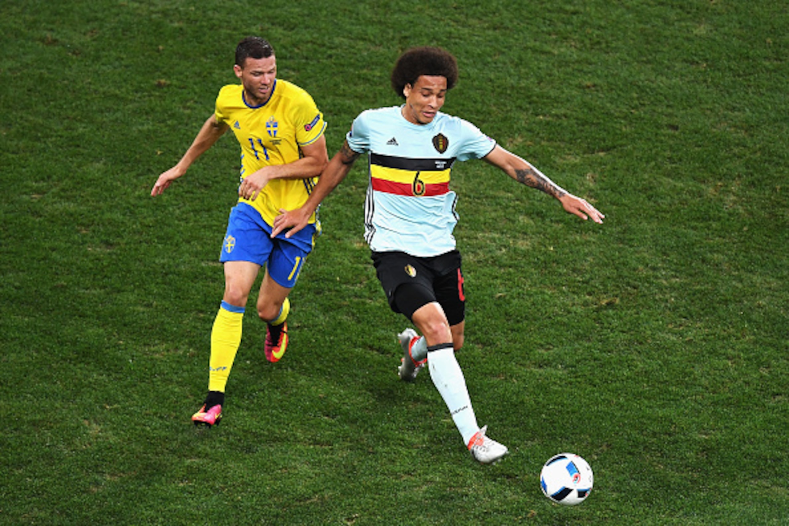 NICE, FRANCE - JUNE 22:  Axel Witsel of Belgium is challenged by Marcus Berg of Sweden during the UEFA EURO 2016 Group E match between Sweden and Belgium at Allianz Riviera Stadium on June 22, 2016 in Nice, France.  (Photo by Laurence Griffiths/Getty Imag