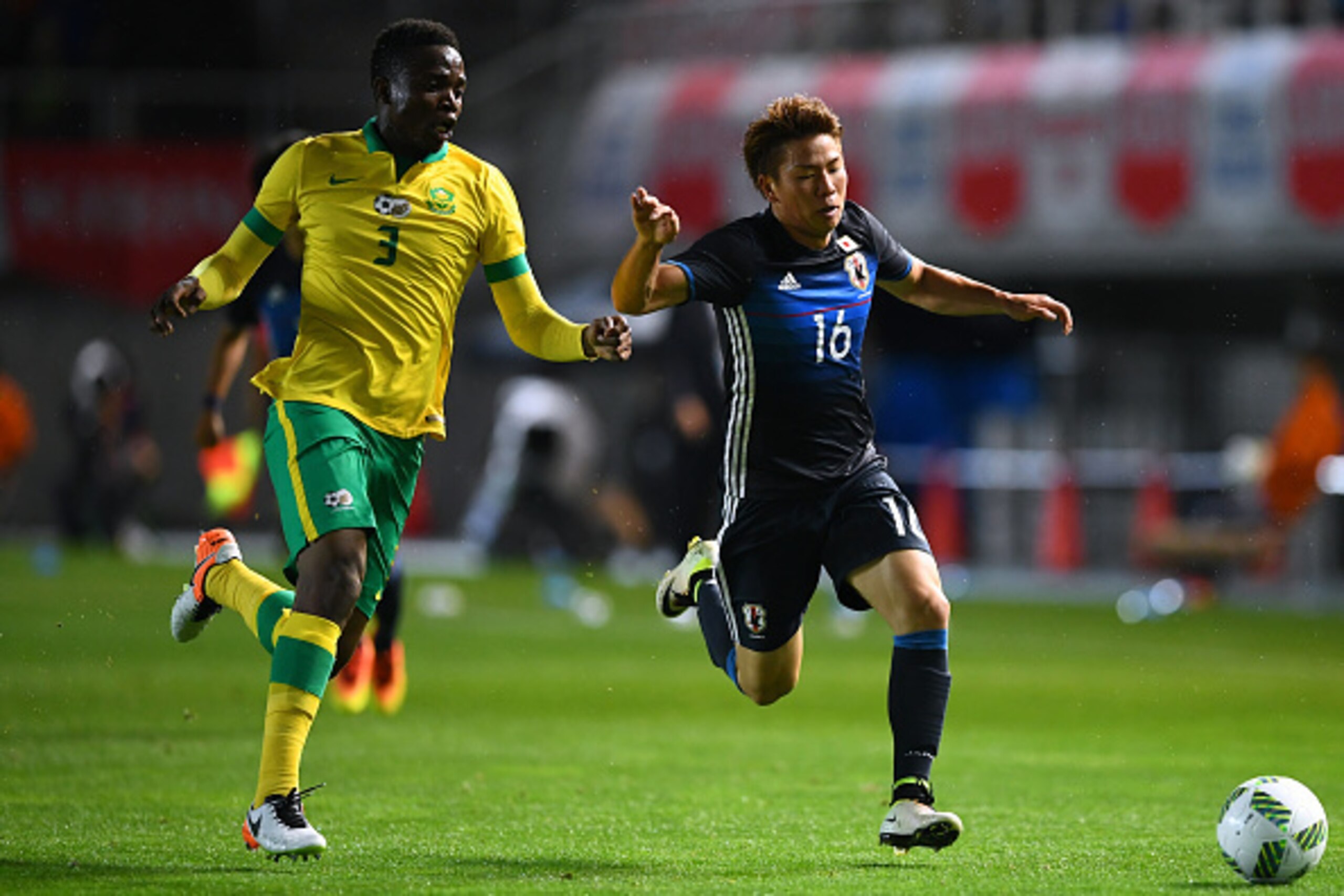 MATSUMOTO, JAPAN - JUNE 29:  Takuma Asano of Japan and Tshepo Rikhotso of South Africa compete for the ball during the U-23 international friendly match between Japan v South Africa at the Matsumotodaira Football Stadium  on June 29, 2016 in Matsumoto, Na