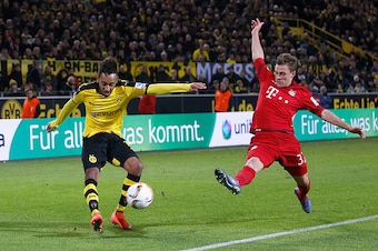 DORTMUND, GERMANY - MARCH 05:  Pierre-Emerick Aubameyang (L) of Borussia Dortmund is challenged by Joshua Kimmich of Bayern Munich during the Bundesliga match between Borussia Dortmund and FC Bayern Muenchen at Signal Iduna Park on March 5, 2016 in Dortmu