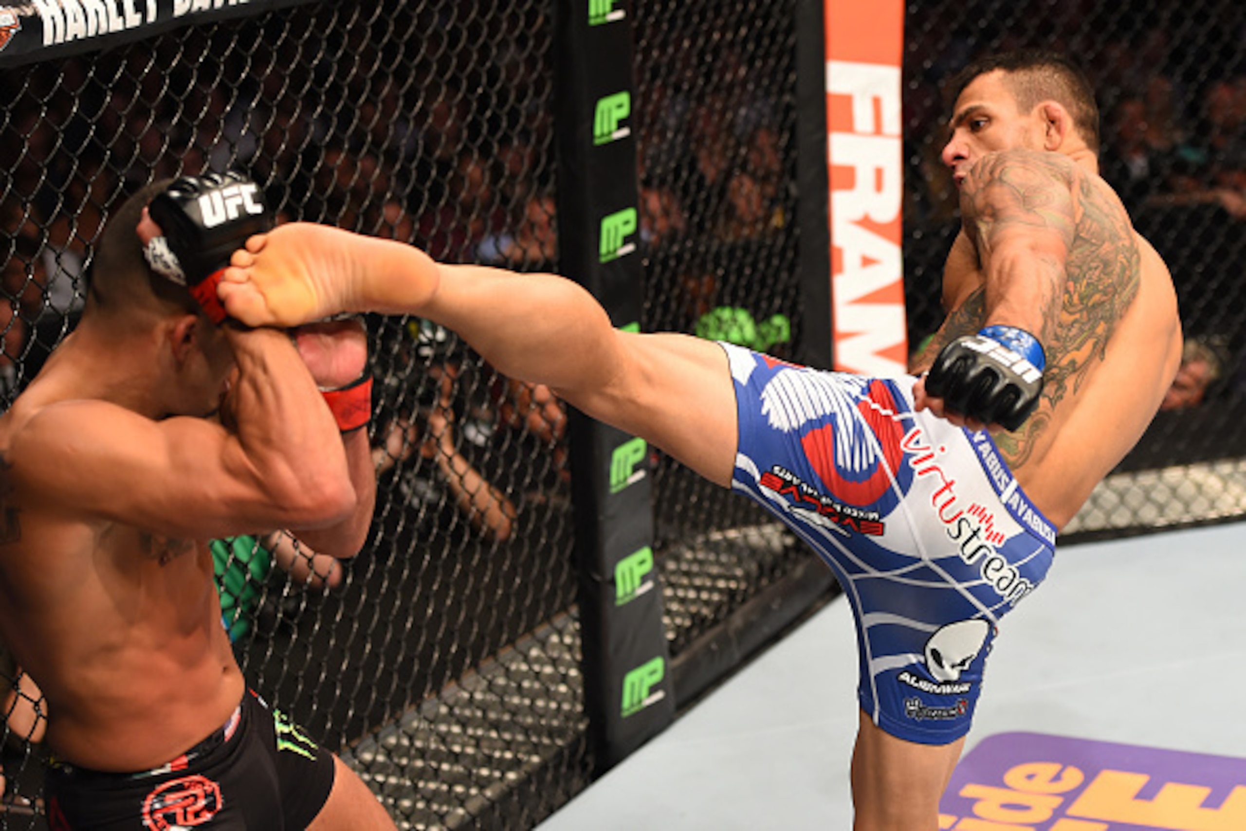 DALLAS, TX - MARCH 14:  (R-L) Rafael dos Anjos of Brazil kicks Anthony Pettis in their UFC lightweight championship bout during the UFC 185 event at the American Airlines Center on March 14, 2015 in Dallas, Texas. (Photo by Josh Hedges/Zuffa LLC/Zuffa LLC