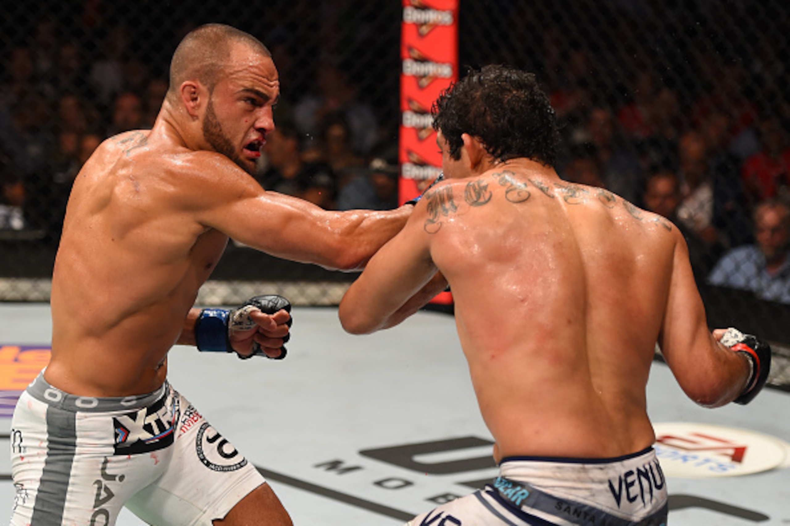MEXICO CITY, MEXICO - JUNE 13:  (L-R) Eddie Alvarez of the United States punches Gilbert Melendez of the United States in their lightweight bout during the UFC 188 event at the Arena Ciudad de Mexico on June 13, 2015 in Mexico City, Mexico. (Photo by Josh