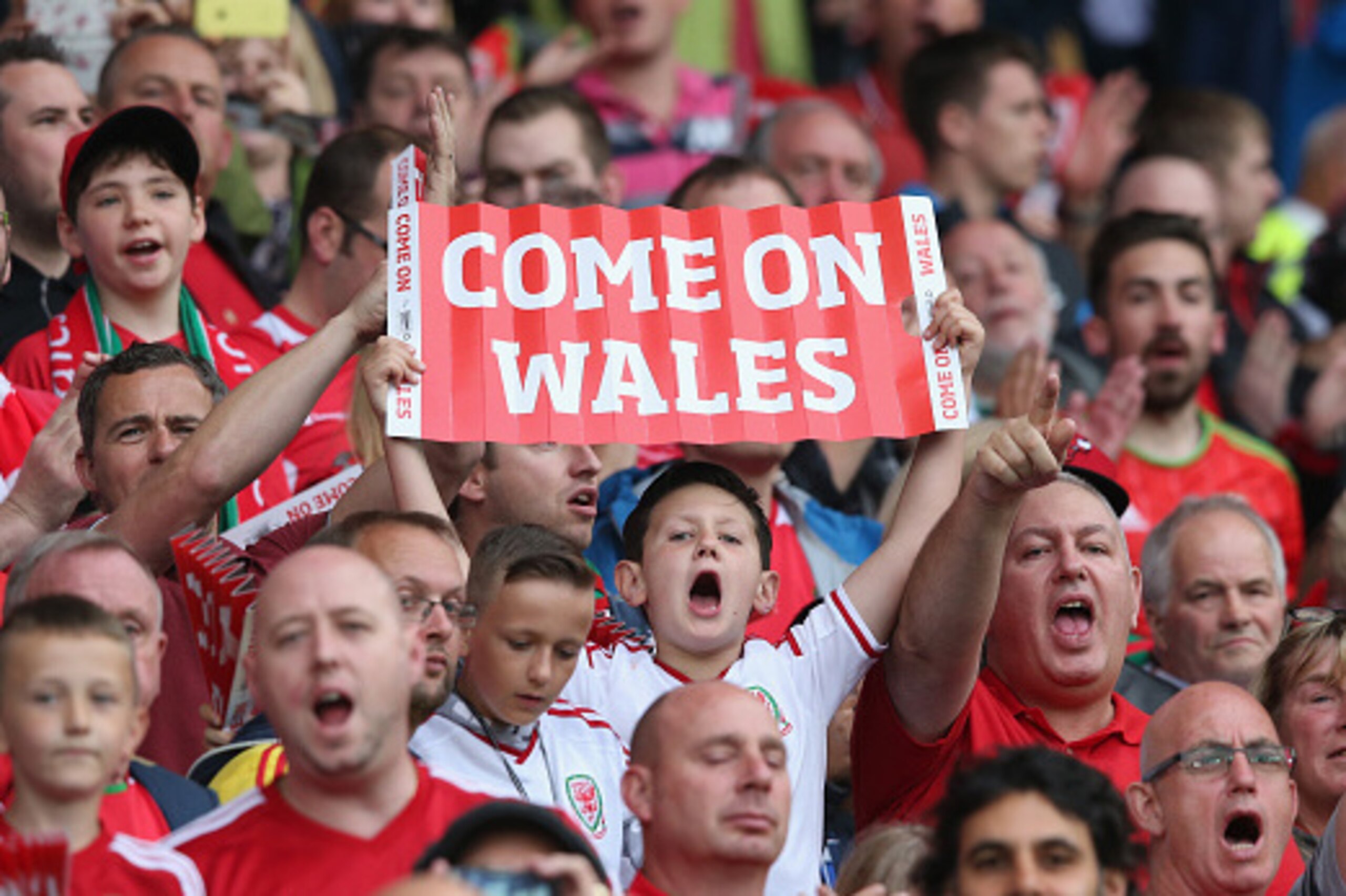 CARDIFF, WALES - JUNE 12:  Wales fans shout encourgement  to their team during the UEFA EURO 2016 qualifying match between Wales and Belgium at the Cardiff City Stadium on June 12, 2015 in Cardiff, United Kingdom.  (Photo by David Rogers/Getty Images)