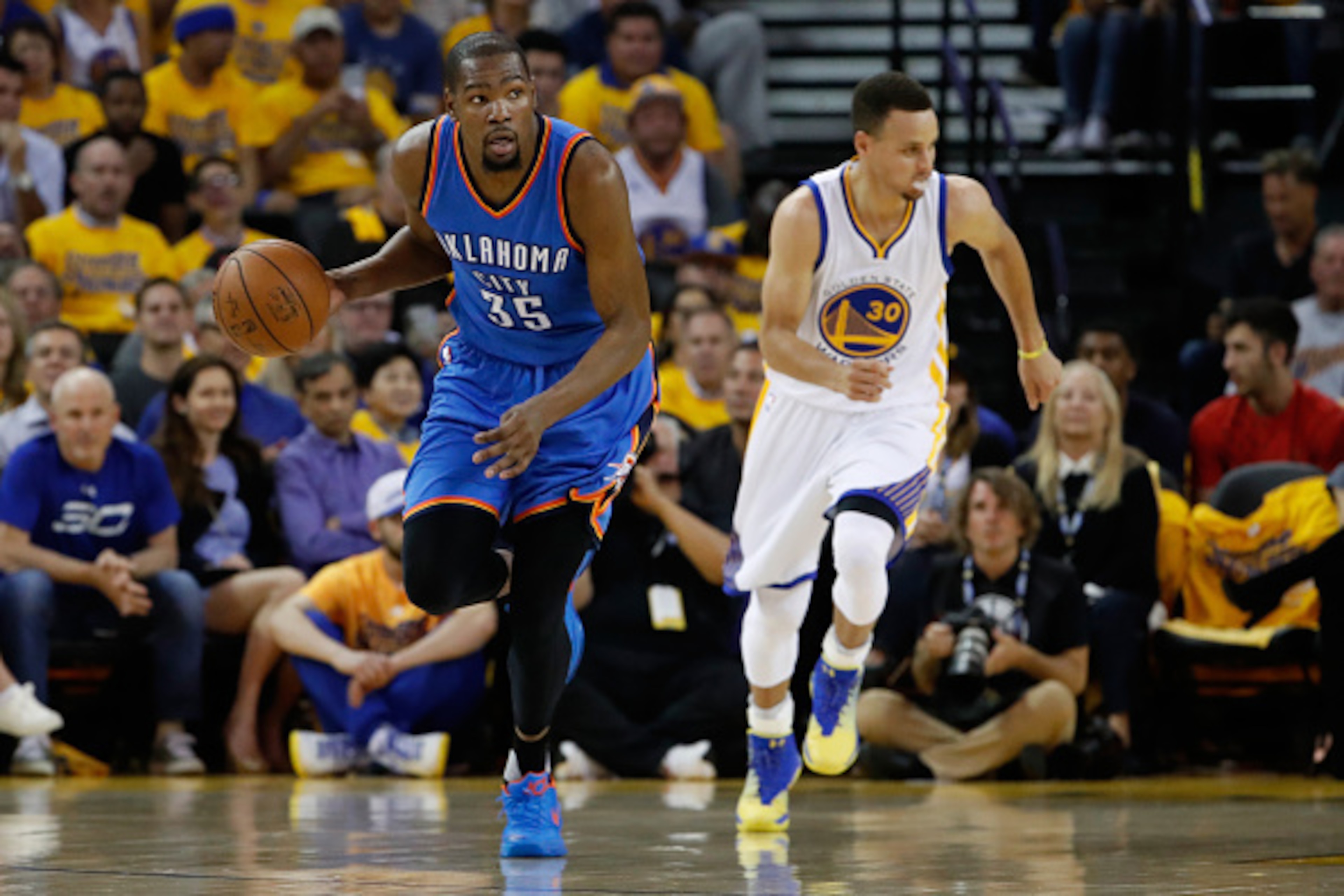 OAKLAND, CA - MAY 18:  Kevin Durant #35 of the Oklahoma City Thunder brings the ball upcourt ahead of Stephen Curry #30 of the Golden State Warriors during game two of the Western Conference Finals during the 2016 NBA Playoffs at ORACLE Arena on May 18, 2