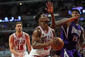 CHICAGO, IL - MARCH 21: Jimmy Butler #21 of the Chicago Bulls drives past DeMarcus Cousins #15 of the Sacramento Kings at the United Center on March 21, 2016 in Chicago, Illinois. The Bulls defeated the Kings 109-102. NOTE TO USER: User expressly acknowle