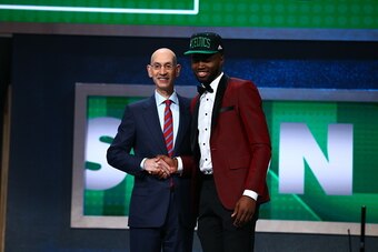 BROOKLYN, NY - JUNE 23: Jaylen Brown shakes hands with NBA Commissioner Adam Silver after being selected number three overall by the Boston Celtics during the 2016 NBA Draft on June 23, 2015 at Barclays Center in Brooklyn, New York. NOTE TO USER: User exp