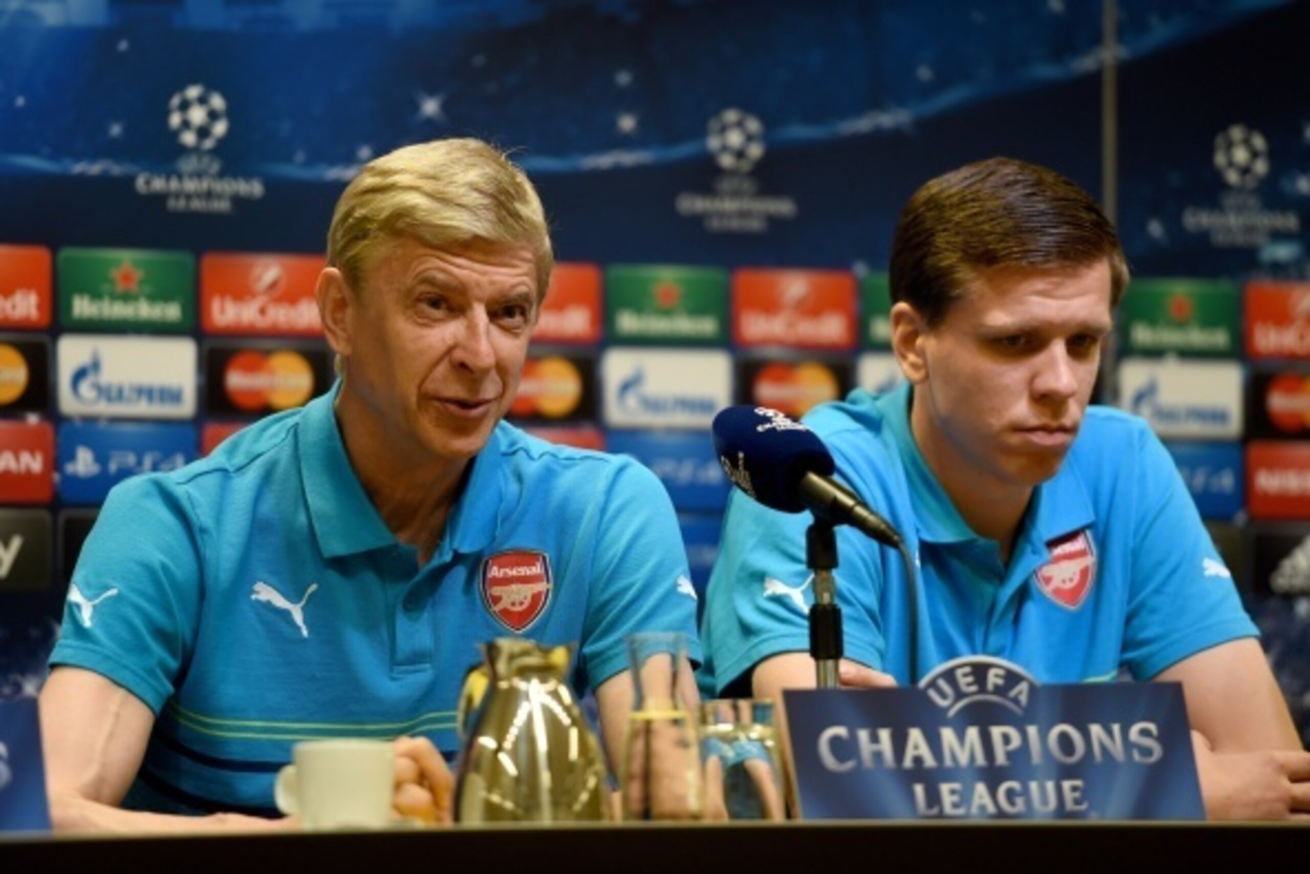 Arsenal´s French head coach Arsene Wenger and Arsenal´s Polish goalkeeper Wojciech Szczesny answer questions during a press conference in Dortmund, western Germany on September 15, 2014, on the eve of the first leg UEFA Champions League Group D football m