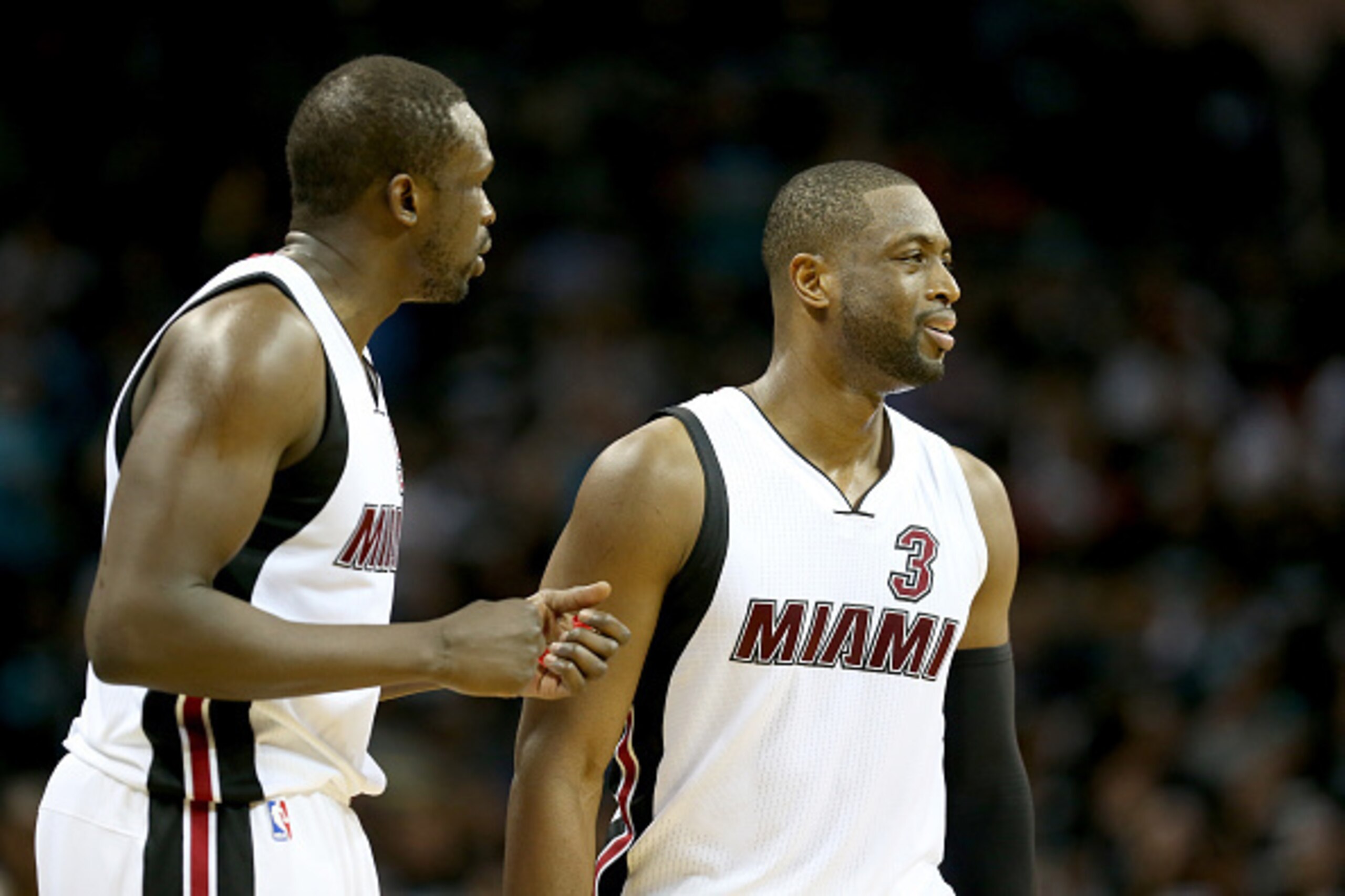 CHARLOTTE, NC - APRIL 23:  Teammates Luol Deng #9 and Dwyane Wade #3 of the Miami Heat react after a play against the Charlotte Hornets during game three of the Eastern Conference Quarterfinals of the 2016 NBA Playoffs at Time Warner Cable Arena on April 