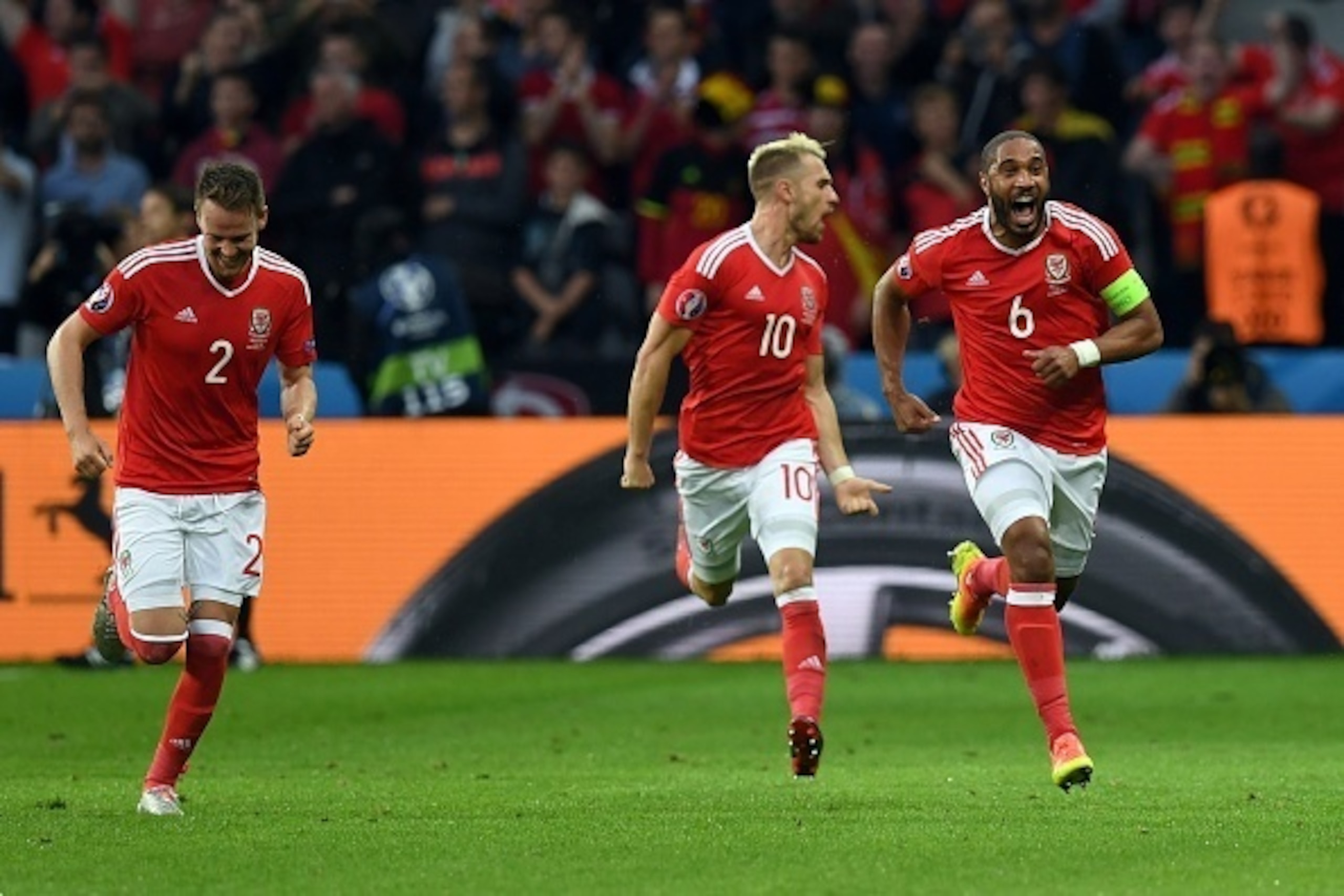 Wales' defender Ashley Williams (R) celebrates after scoring a goal with team mates Wales' defender Chris Gunter and Wales' midfielder Aaron Ramsey during the Euro 2016 quarter-final football match between Wales and Belgium at the Pierre-Mauroy stadium i Wales' defender Ashley Williams (R) celebrates after scoring a goal with team mates Wales' defender Chris Gunter and Wales' midfielder Aaron Ramsey during the Euro 2016 quarter-final football match between Wales and Belgium at the Pierre-Mauroy stadium i